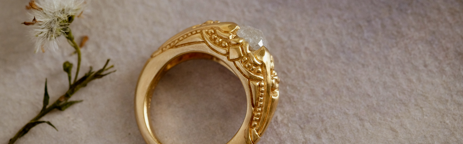 hand-carved gold and precious gemstones that evoke an old world aesthetic, it is a touchstone for your life–the transient marked by the enduring.