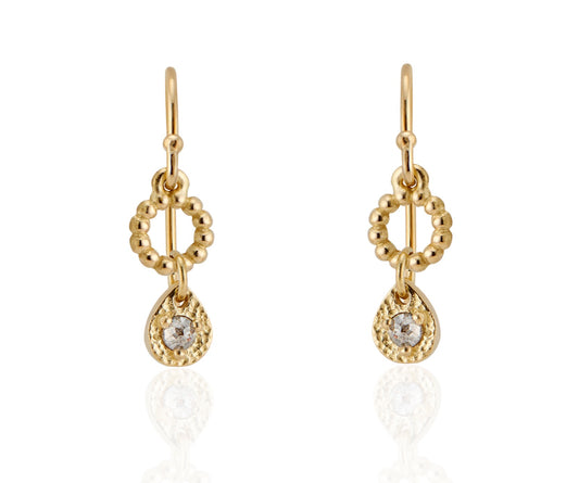 A romantic journey that transcends time. The Drop earring merges a circle of understated gold beads with ornate rose cut diamonds for a dangling romantic style that feels as at home today as it does in an antique jewelry box. 