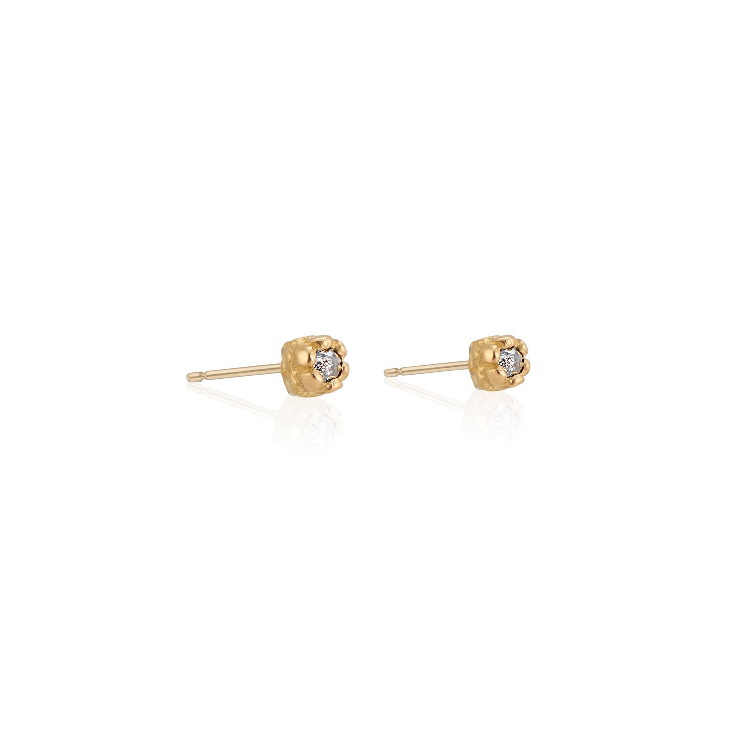 Inspired by a set of rings purchased for a childhood crush, the Bey earrings merge the simplicity of days past with a refined sophistication. Hand-crafted gold petals form a cocoon around a stunning rose cut diamond, creating delicate earrings perfect for celebrating the everyday.