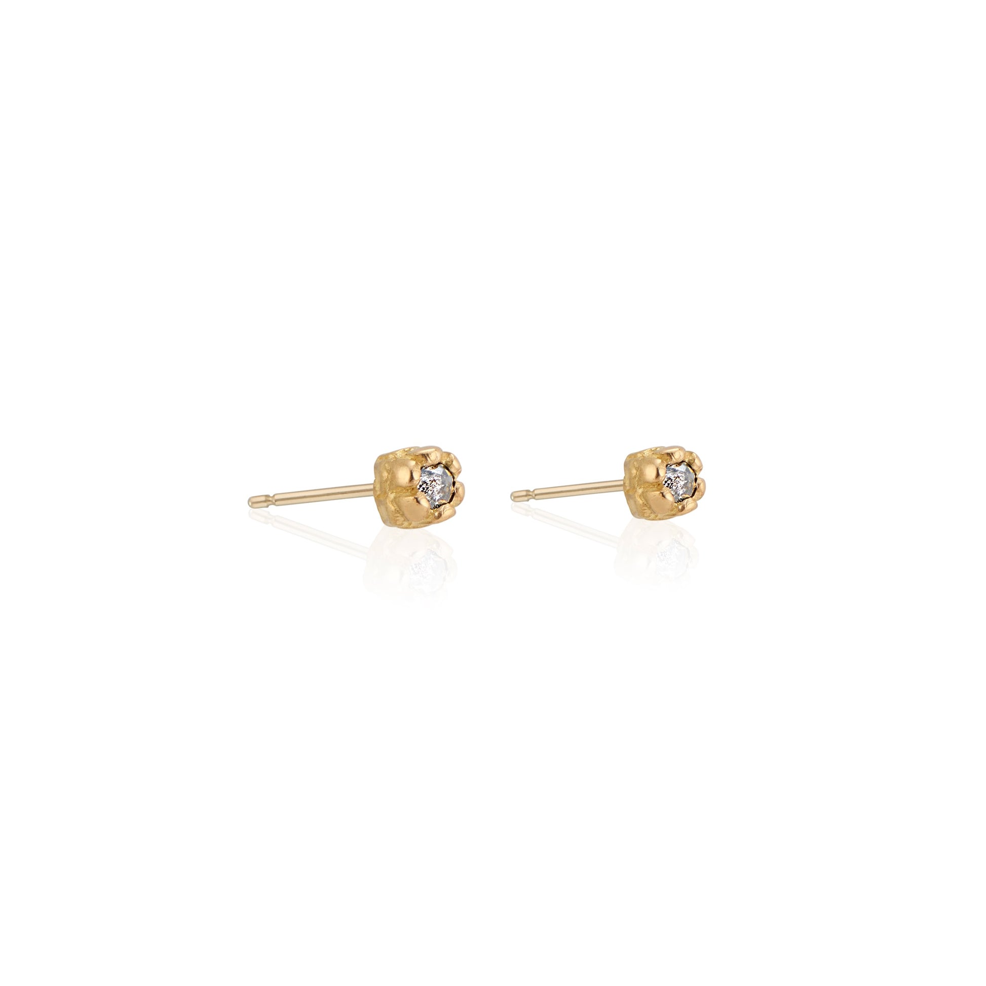 Inspired by a set of rings purchased for a childhood crush, the Bey earrings merge the simplicity of days past with a refined sophistication. Hand-crafted gold petals form a cocoon around a stunning rose cut diamond, creating delicate earrings perfect for celebrating the everyday.