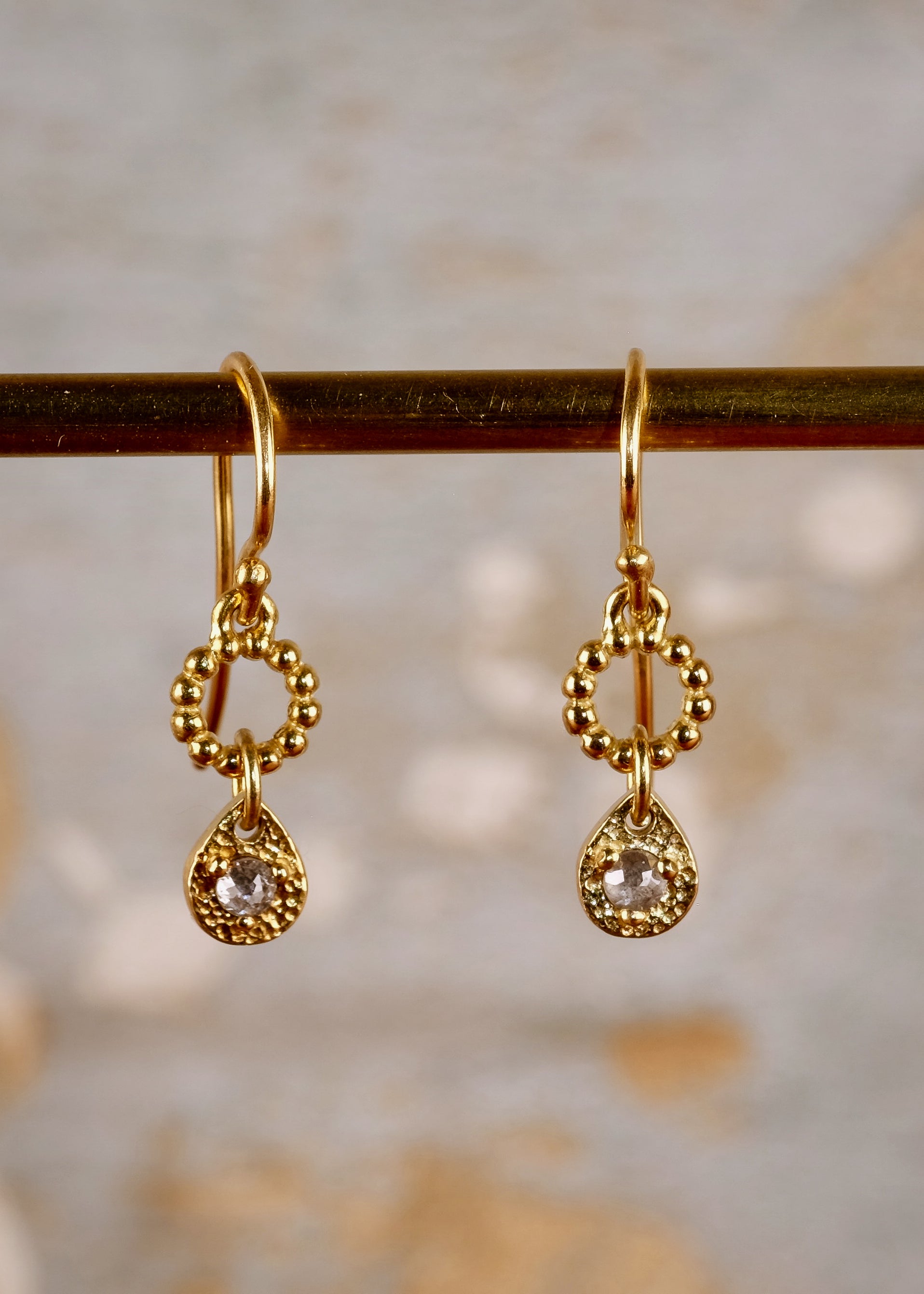 A romantic journey that transcends time. The Drop earring merges a circle of understated gold beads with ornate rose cut diamonds for a dangling romantic style that feels as at home today as it does in an antique jewelry box.