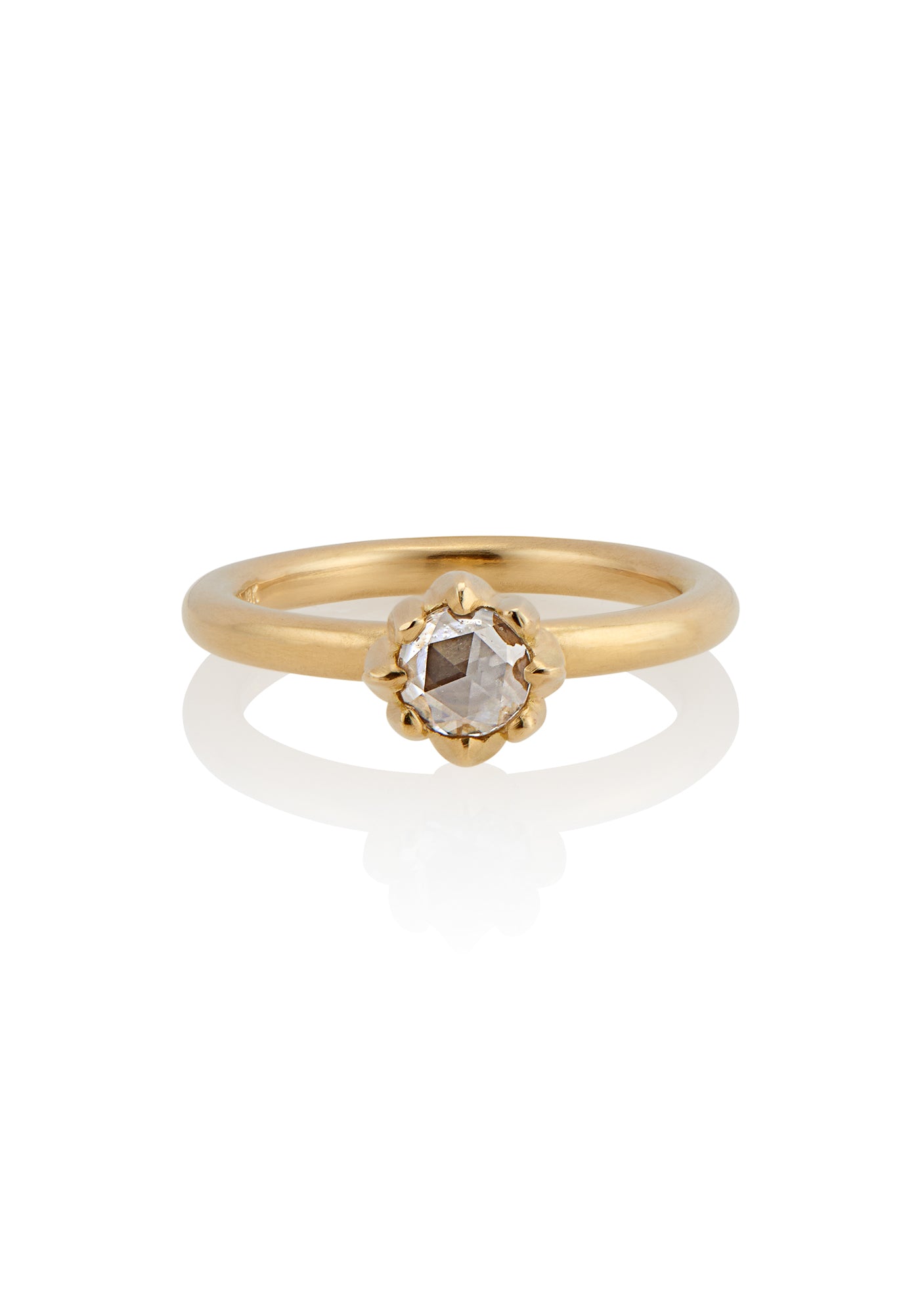 In simplicity, majesty is revealed. Inspired by the stark and graphic botanical photographs of Karl Blossfeldt, the Fleur ring creates a striking silhouette on the finger, its clean gold band showcasing a regal and romantic rose cut diamond.