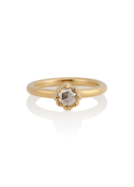 In simplicity, majesty is revealed. Inspired by the stark and graphic botanical photographs of Karl Blossfeldt, the Fleur ring creates a striking silhouette on the finger, its clean gold band showcasing a regal and romantic rose cut diamond.