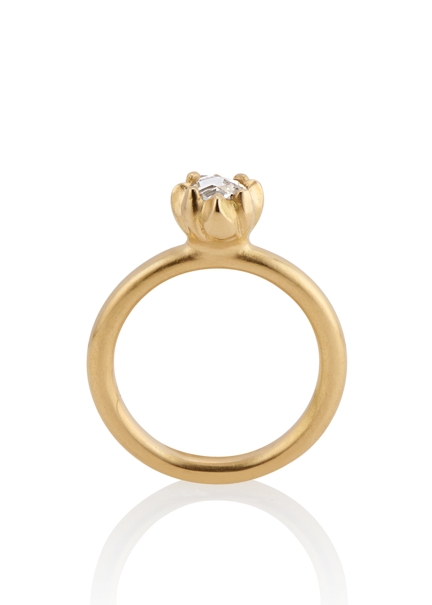 In simplicity, majesty is revealed. Inspired by the stark and graphic botanical photographs of Karl Blossfeldt, the Fleur ring creates a striking silhouette on the finger, its clean gold band showcasing a regal and romantic rose cut diamond.