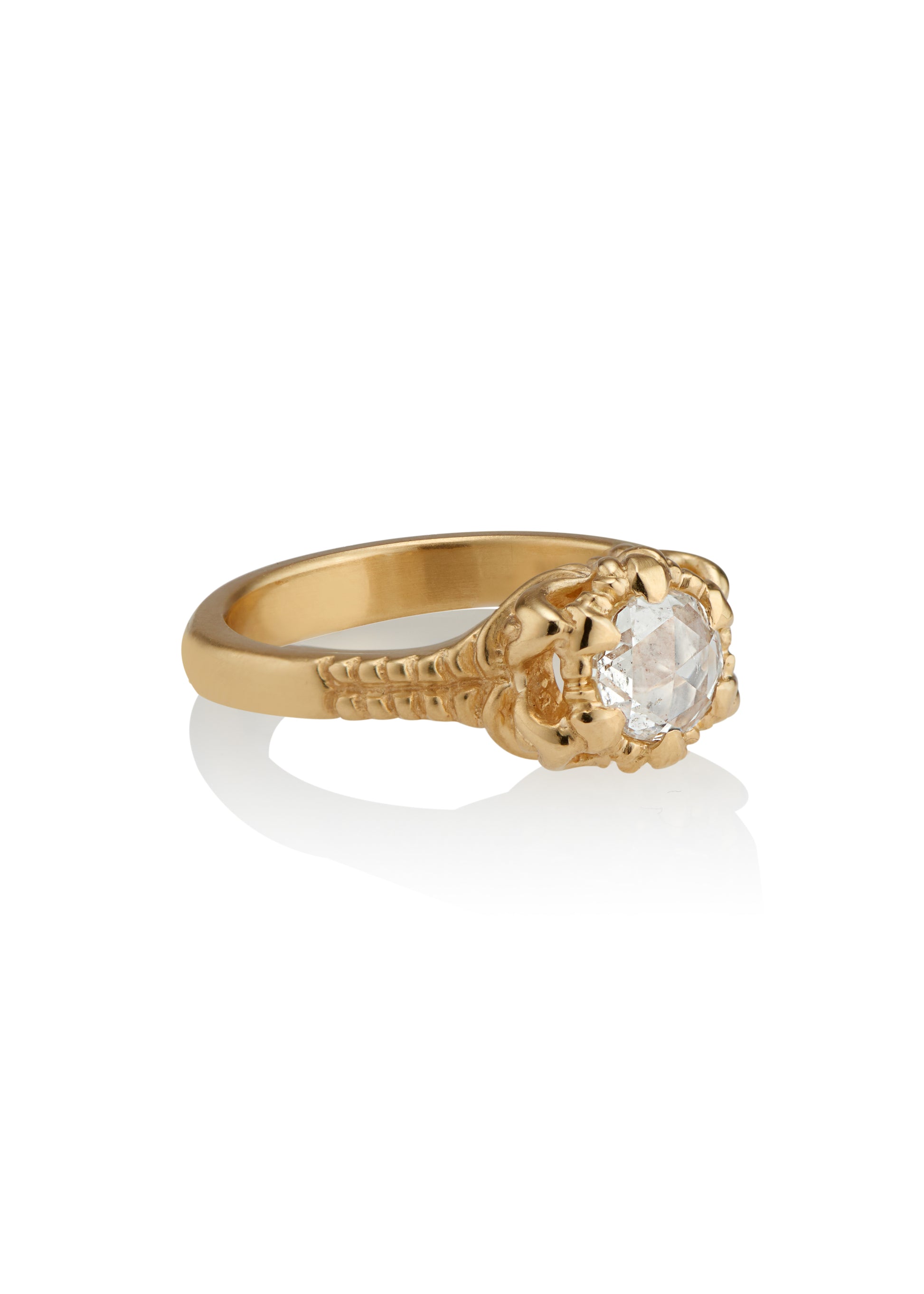 A mythical creature who continues to captivate the imagination, Lilith’s hair was referred to by the poet Rosetti as “the first gold.” A gleaming rose cut diamond is set among an intricately detailed gold band—an homage to Lilith’s ability to cast her spell wherever she goes.