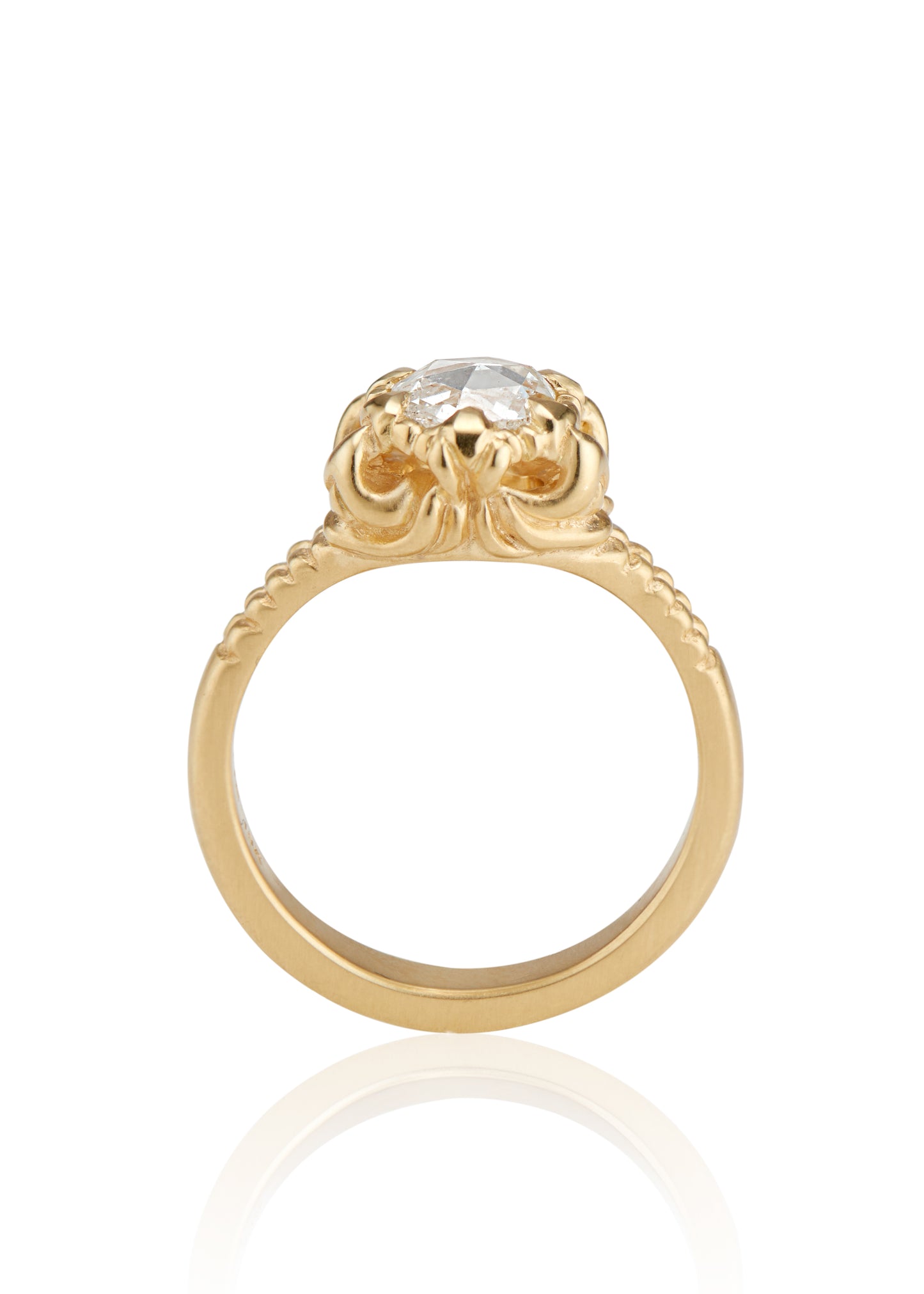 A mythical creature who continues to captivate the imagination, Lilith’s hair was referred to by the poet Rosetti as “the first gold.” A gleaming rose cut diamond is set among an intricately detailed gold band—an homage to Lilith’s ability to cast her spell wherever she goes.