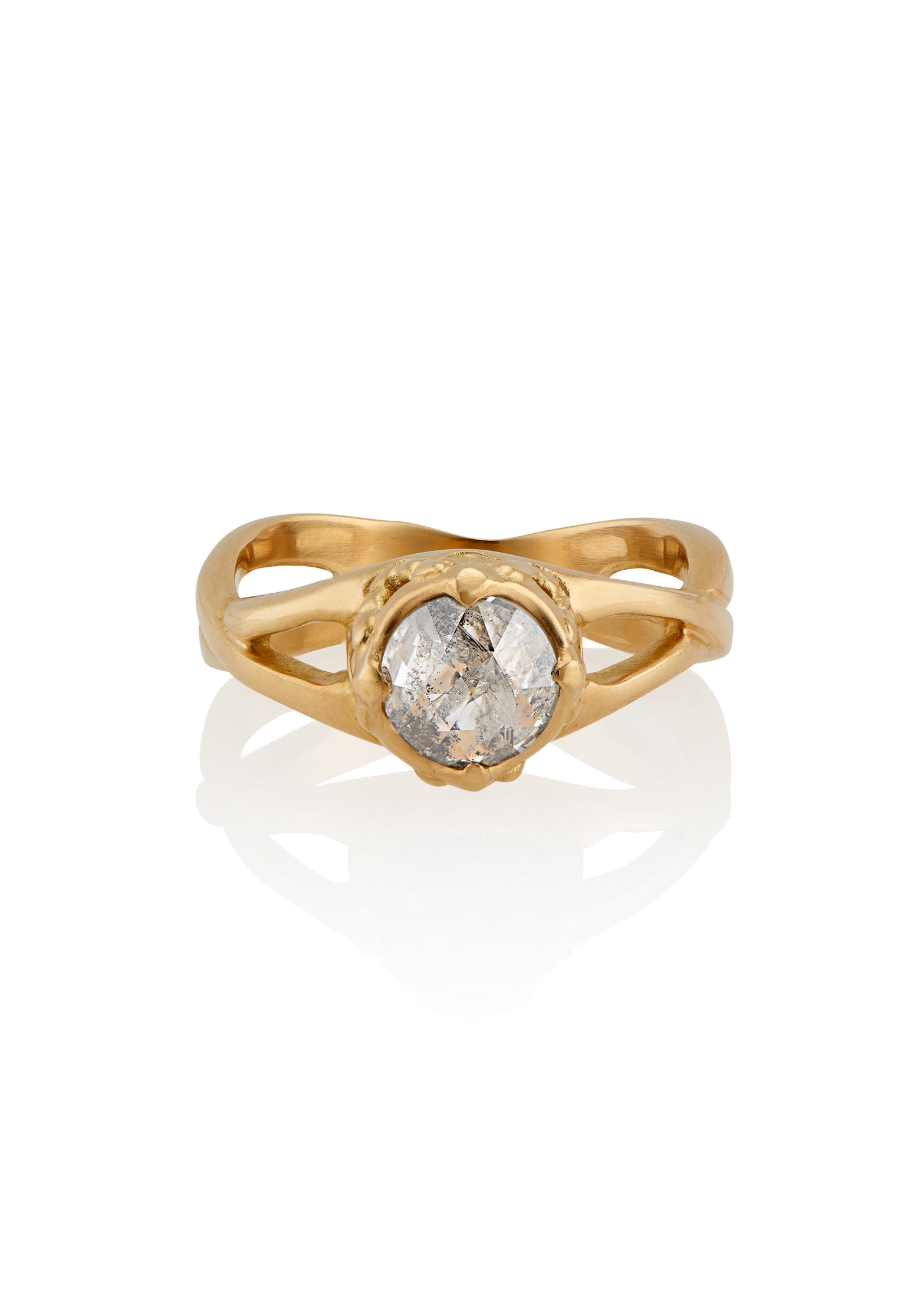 Capturing the Gothic beauty of a haunted mansion, the Liota ring is named for a woman whose gossamer spirit transcends time. Gold bands criss cross around the finger to buttress a brilliant rose cut diamond nestled among ornate carvings—an architectural ring that echoes the past while celebrating the eternal.