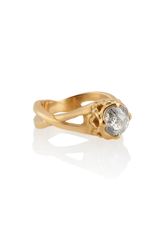 Capturing the Gothic beauty of a haunted mansion, the Liota ring is named for a woman whose gossamer spirit transcends time. Gold bands criss cross around the finger to buttress a brilliant rose cut diamond nestled among ornate carvings—an architectural ring that echoes the past while celebrating the eternal.