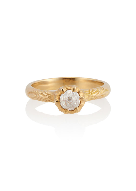 Like the haunting notes of a Glenn Miller Orchestra record, the Perfidia ring ascends to prominence on the finger to captivate all who bear witness to such beauty. Delicate details on the gold band give way to a textured pattern that holds a rose cut diamond, an exquisite work of ornate craftsmanship.