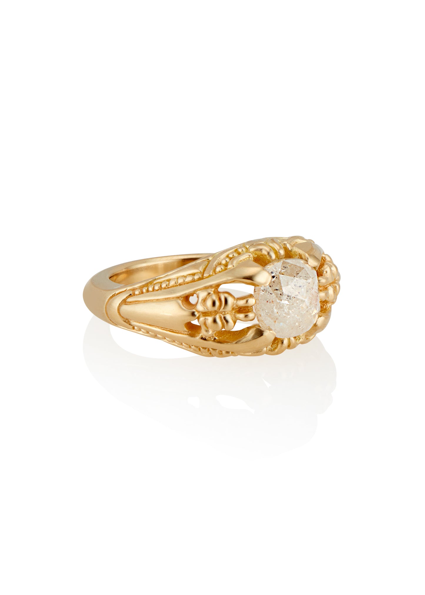 Capturing the ornate details of the Victorian era, the Violette ring was inspired by the love between Prince Albert and Queen Victoria. A substantial gold band is rich in intricate detail, showcasing craftsmanship with each bead, curve and open space. A stunning rose cut diamond sits flush among the prongs, creating a romantic ring to cherish for the ages.
