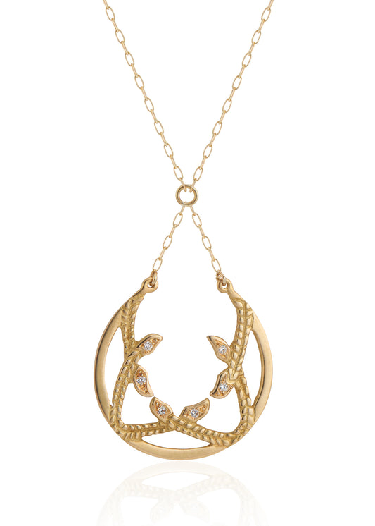 Inspired by the female prophets who share its name, the Sibyl necklace whispers the mysteries of the future while echoing stories of days past. Smooth open-work crescents give way to intertwining textured elements, hand-carved to draw the eye in and reveal brilliant diamond accents—a substantial and haunting design that’s decidedly feminine.