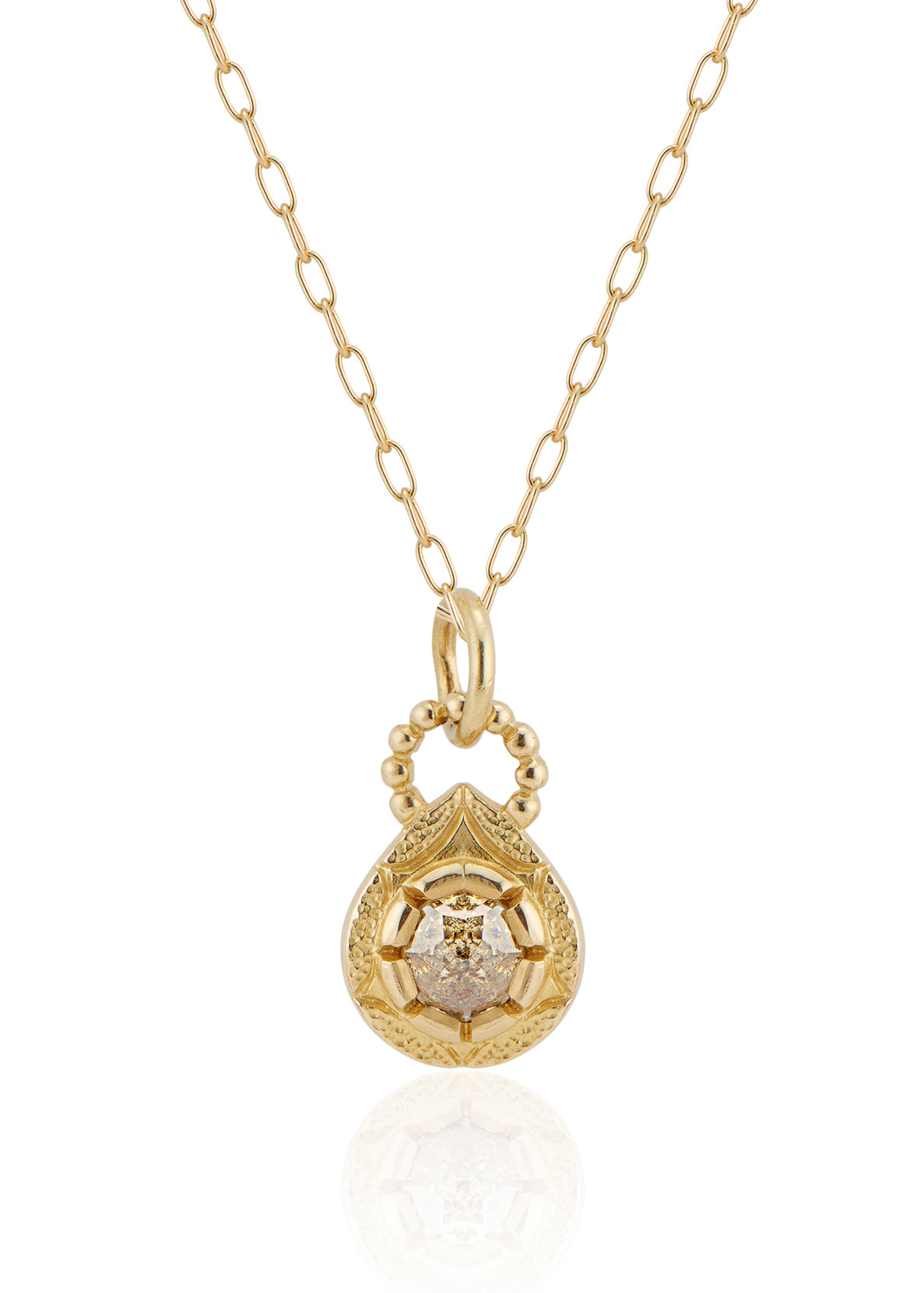 The Solo necklace revels in its unencumbered beauty. A stunning rose cut diamond is cradled in a gold droplet, revealing delicate texture and detail. An intricate beaded arch balances the pendant, linking it to its chain while showcasing its ornate character.