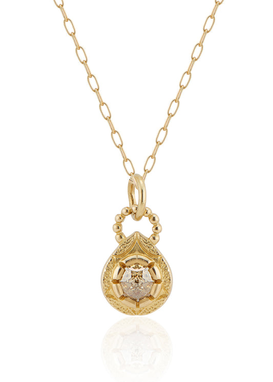 The Solo necklace revels in its unencumbered beauty. A stunning rose cut diamond is cradled in a gold droplet, revealing delicate texture and detail. An intricate beaded arch balances the pendant, linking it to its chain while showcasing its ornate character.