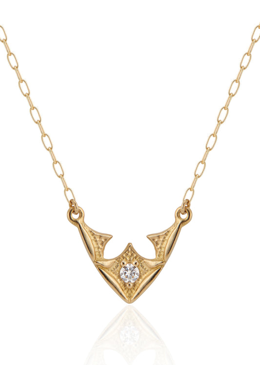 Taken from the French word for “vault,” the Volta necklace is an homage to the Gothic architecture of Paris. Gentle sloping curves give way to acute points, evoking the grandeur of a centuries-old cathedral ceiling. A single diamond catches the eye, complemented by ornate texture and delicate beading—a necklace that transcends time and transports the imagination.