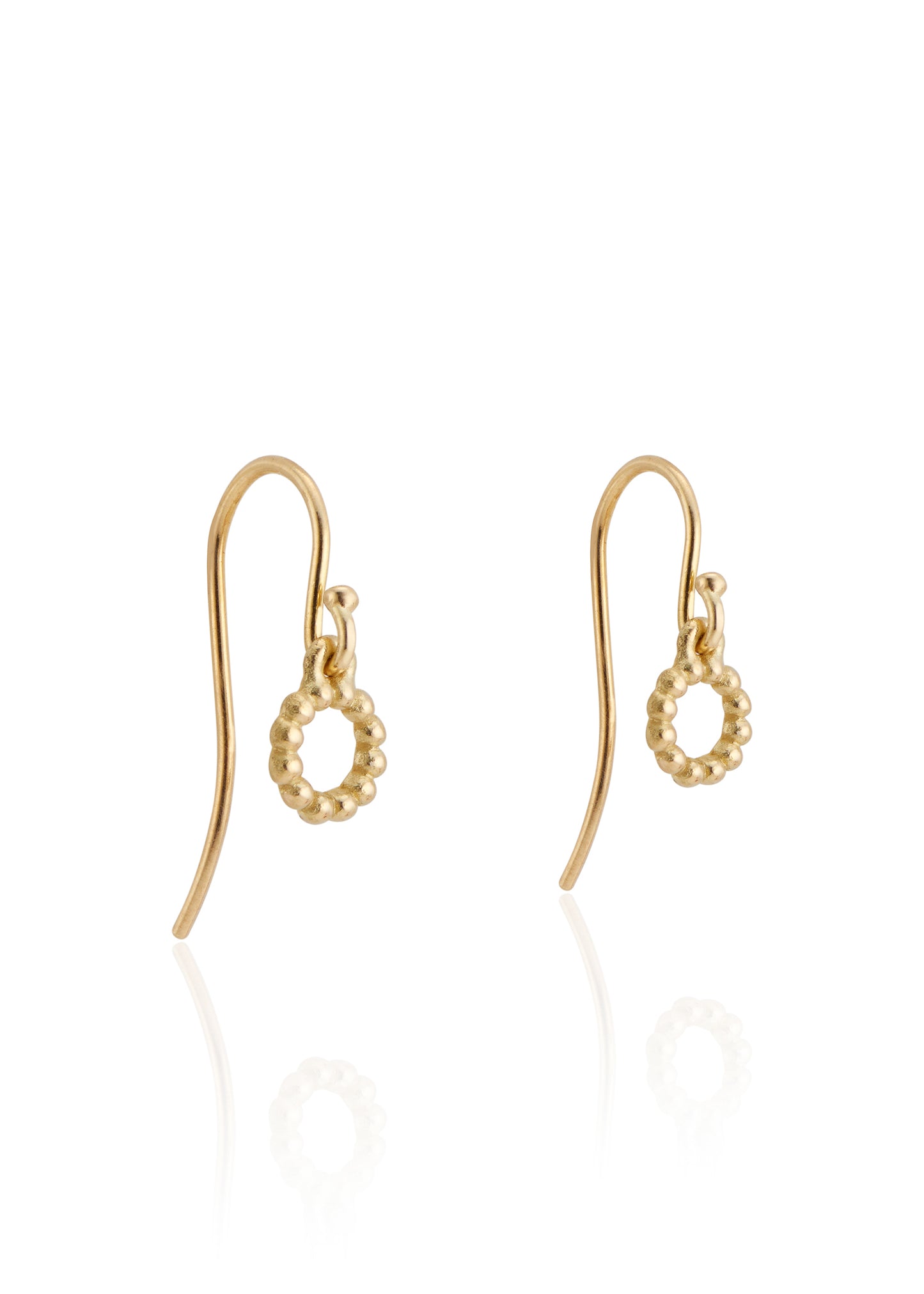 With a classic and understated aesthetic, the Orb earring showcases hand-carved gold beads joined in a perfect ring—a delicate design as timeless as the infinite circle itself.