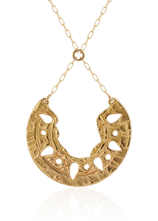 Sun-scorched sand. Glyphs that whisper centuries-old spells. Calling to mind the revered wesekh collars of ancient Egypt, the Demi necklace gleams in a crescent of textured gold. Punctuated with an arresting open-work pattern done by hand, this is a piece that harnesses the mysteries of a world shielded from time.