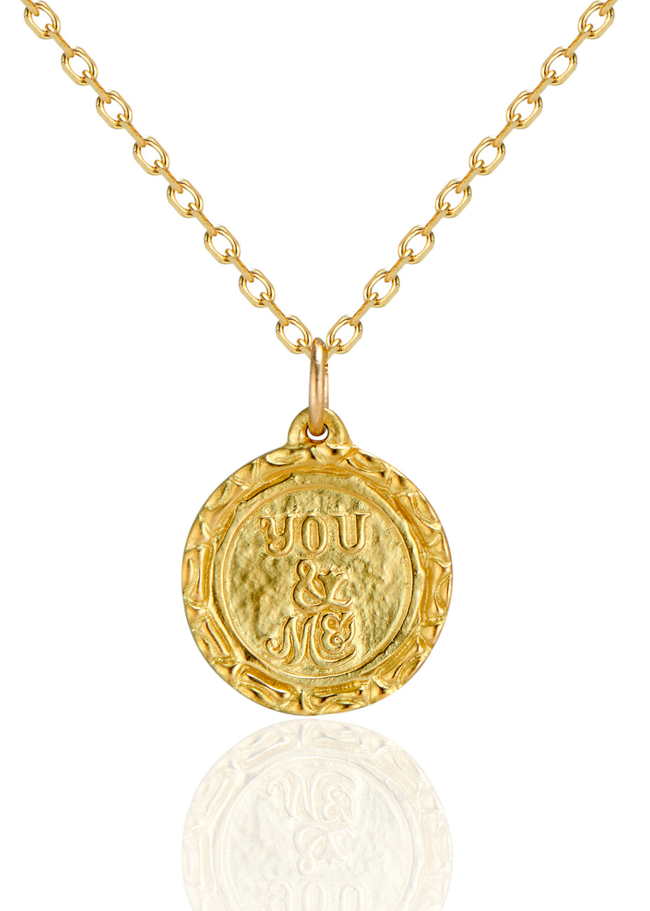 Inspired by “toi et moi” engagement rings from centuries past, the Toi et Moi necklace is a gold pendant engraved by hand to read “Toi et Moi” on one side and “You and Me” on the other. Delicate carving on the edges showcases the beauty of the gold—a piece that’s romantic, sweet, and a promise of things to come.