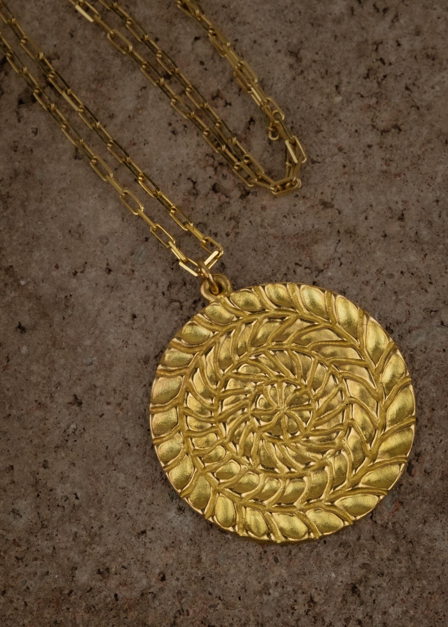 Named for Busby Berkely’s wife, the Etta necklace is a kaleidoscopic wonder that mirrors his elaborate geometric choreography. Four concentric circles, each detailed by hand, create a hypnotic and substantial pendant necklace as timeless as Berkeley’s black and white films.