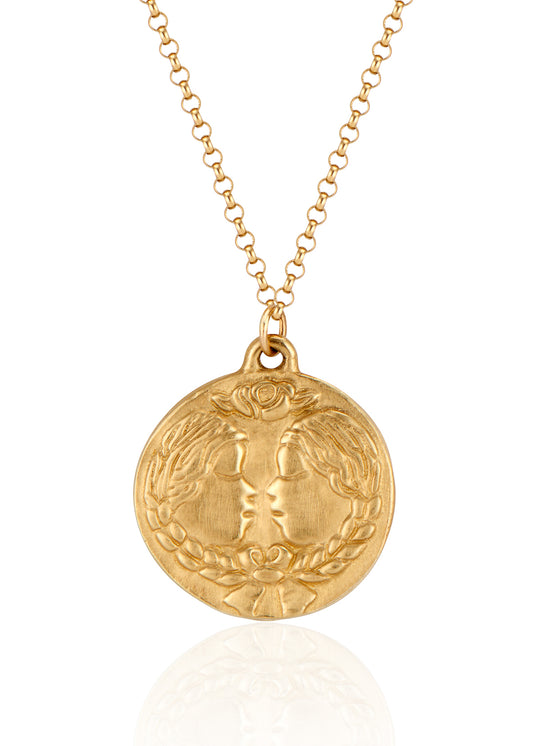 The third sign of the Zodiac, air sign Gemini is quick-witted and curious, with a dual personality that reflects an open mind. Hand-carved twins, bound together by a ribbon, grace this pendant—a necklace that captures the power of the celestial sky.