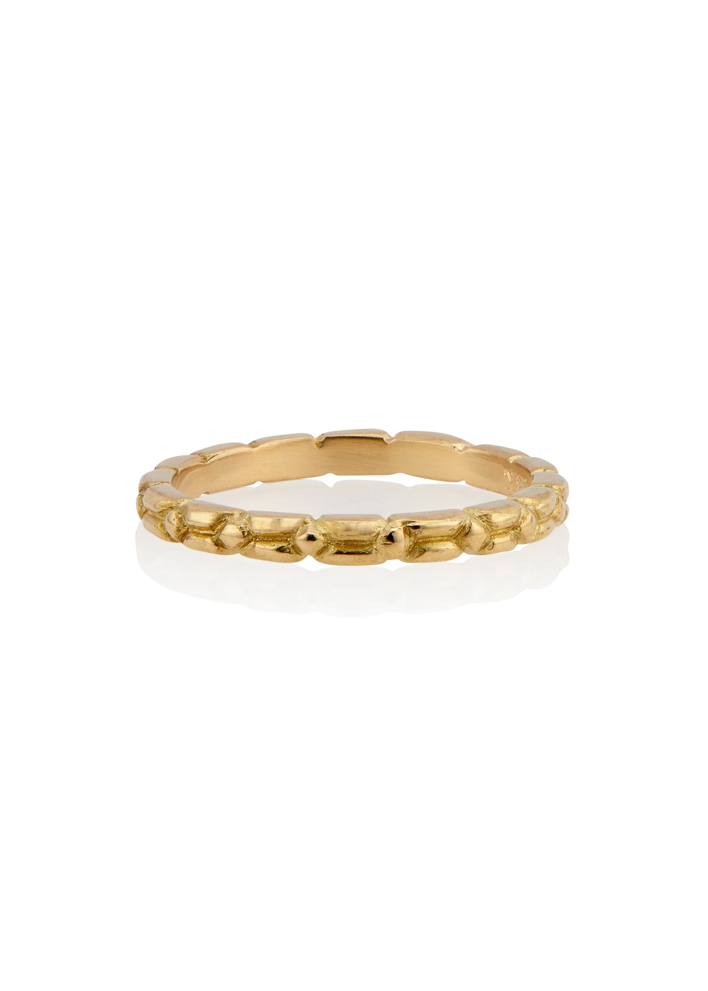 An intricately carved gold band, the Lariat ring is a study in texture—a classic piece rich in craftsmanship.