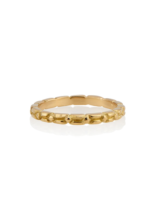 An intricately carved gold band, the Lariat ring is a study in texture—a classic piece rich in craftsmanship.