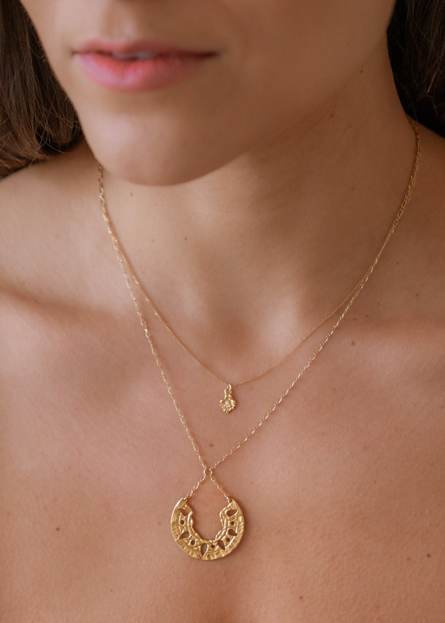 Sun-scorched sand. Glyphs that whisper centuries-old spells. Calling to mind the revered wesekh collars of ancient Egypt, the Demi necklace gleams in a crescent of textured gold. Punctuated with an arresting open-work pattern done by hand, this is a piece that harnesses the mysteries of a world shielded from time.