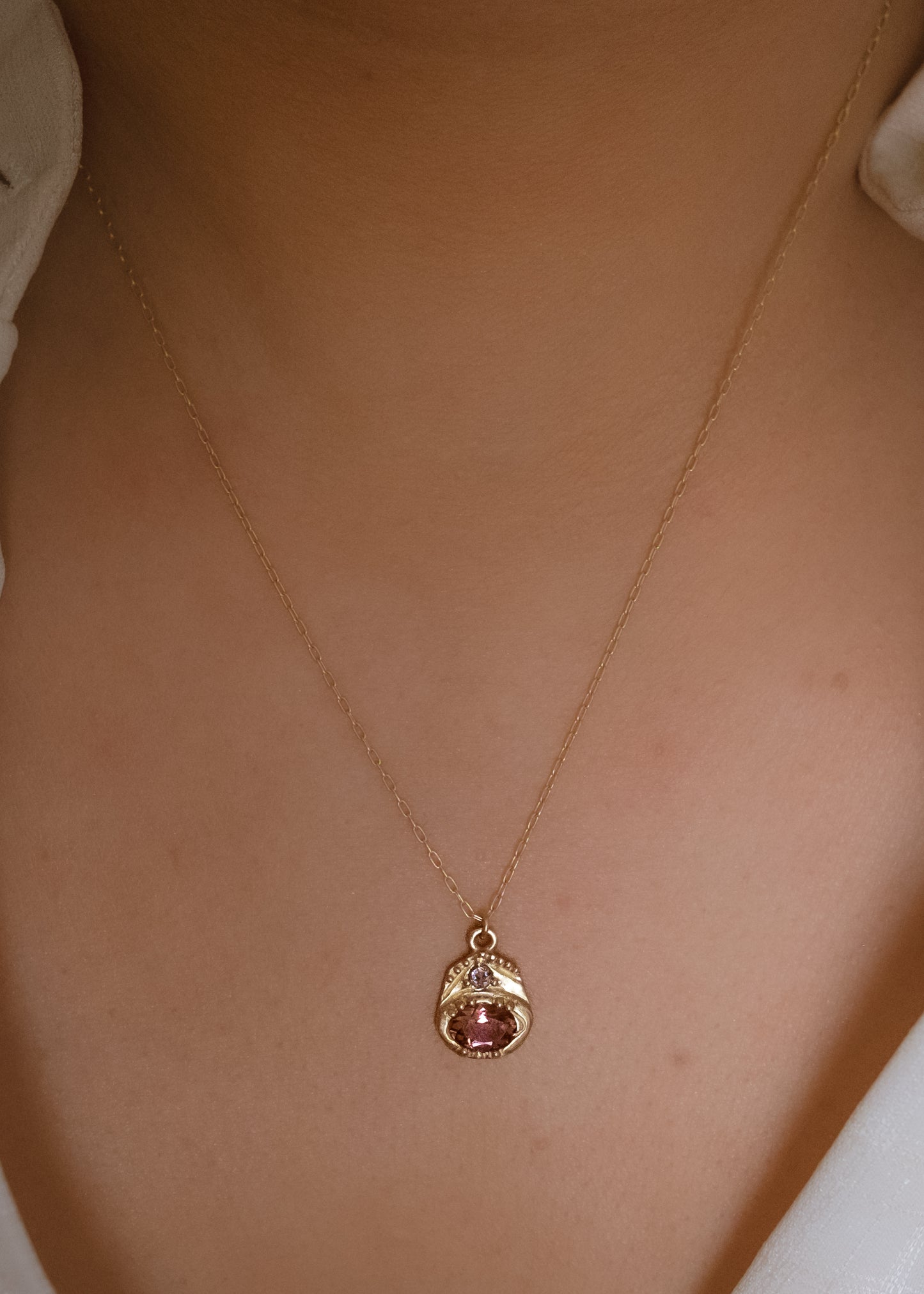 Beyond the creaking floorboards of the antique shop stands a curio cabinet, a sentinel of small treasures redolent with tales of love and lore. Inspired by these cabinets that hold such rare objects, the Curio necklace shines with a stunning oval tourmaline. A rose cut diamond hovers above, a shining crown punctuated by delicate hand-carved gold beads–a necklace worthy of telling your story for generations to come.