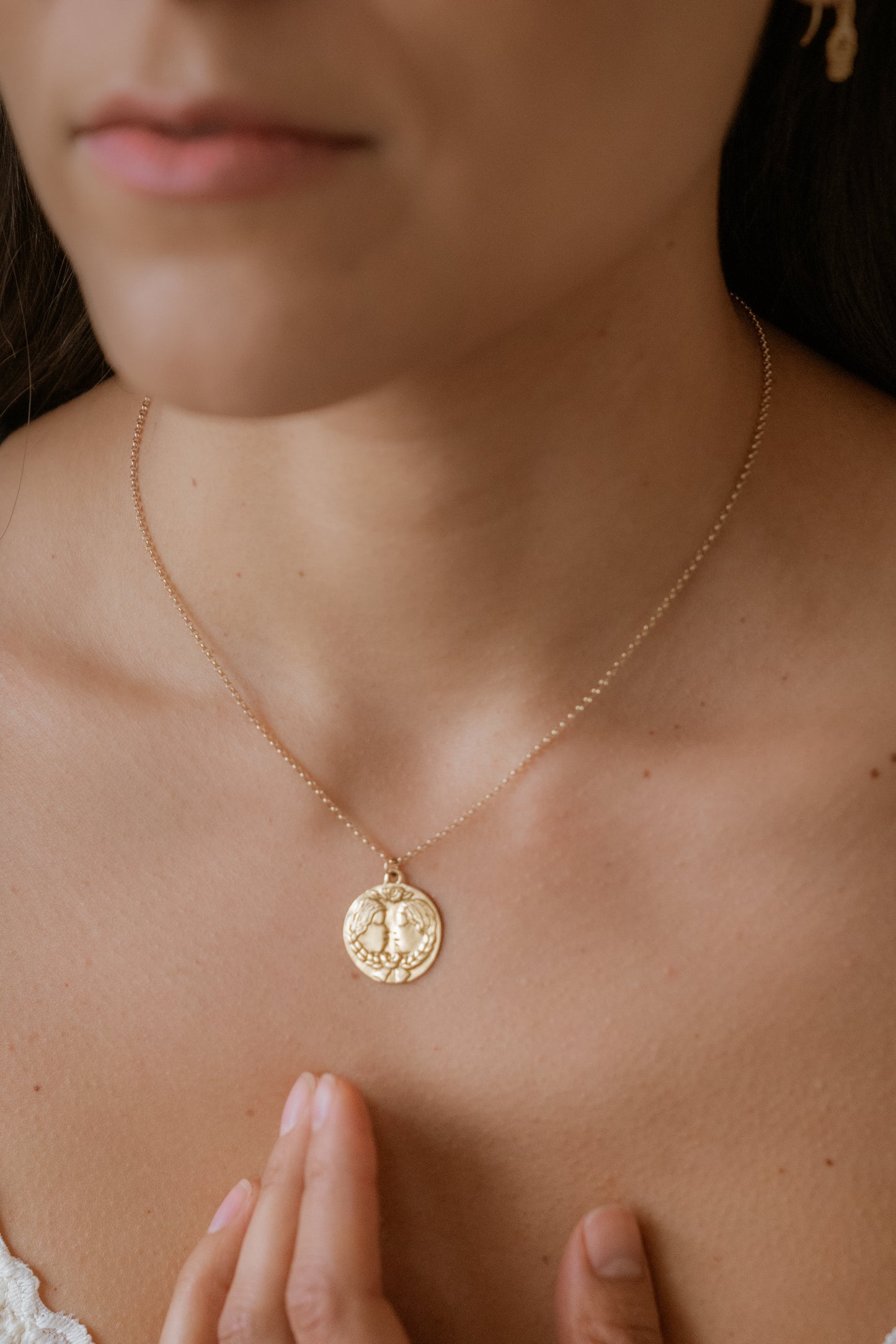 The third sign of the Zodiac, air sign Gemini is quick-witted and curious, with a dual personality that reflects an open mind. Hand-carved twins, bound together by a ribbon, grace this pendant—a necklace that captures the power of the celestial sky.