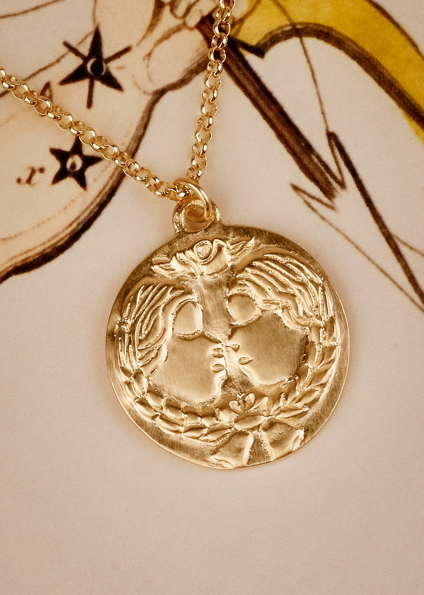The third sign of the Zodiac, air sign Gemini is quick-witted and curious, with a dual personality that reflects an open mind. Hand-carved twins, bound together by a ribbon, grace this pendant—a necklace that captures the power of the celestial sky.