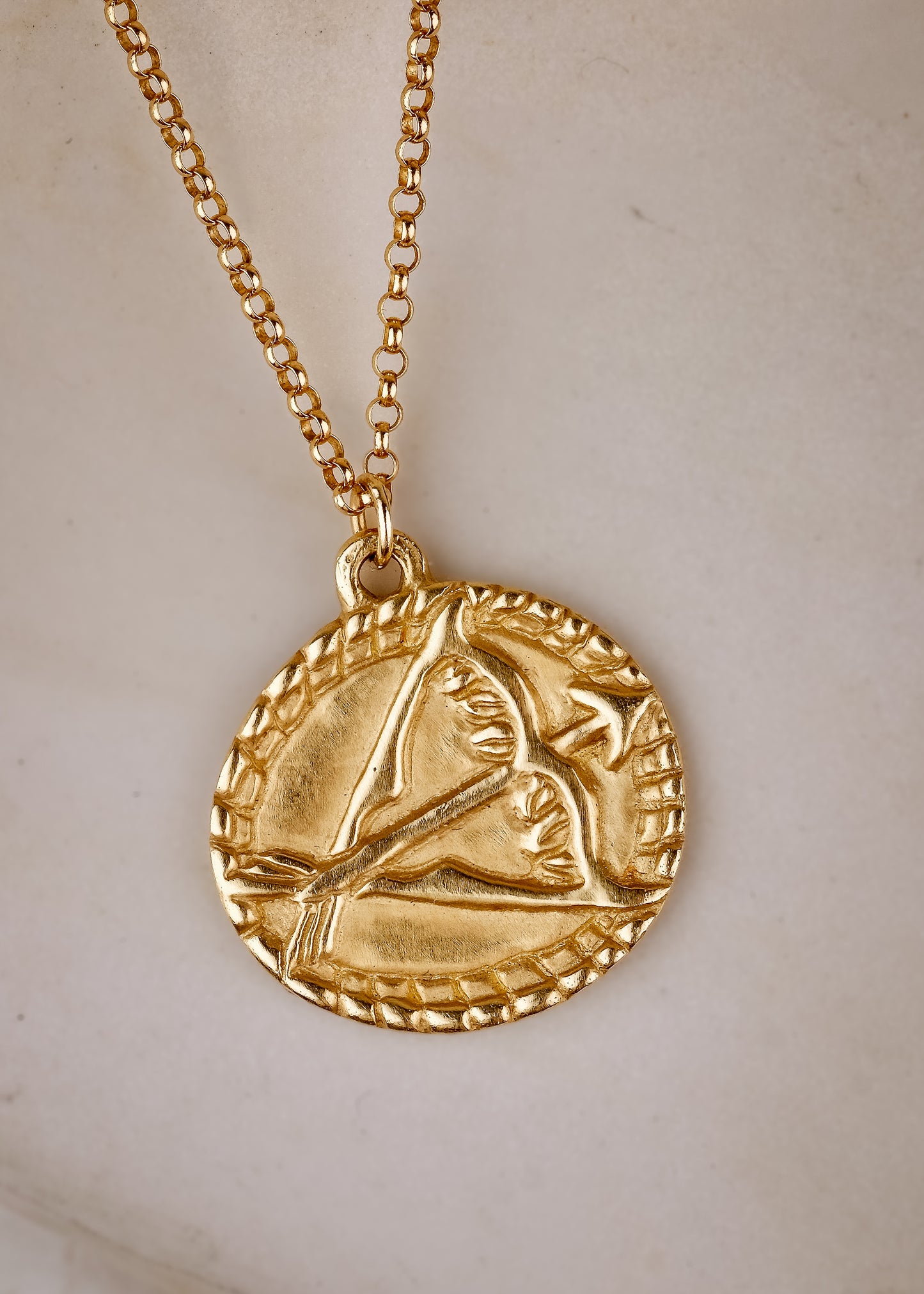 The ninth sign of the Zodiac, fire sign Sagittarius is a passionate traveler whose natural curiosity ignites their adventures. A hand-carved bow and arrow graces this pendant for a necklace that captures the power of the celestial sky.