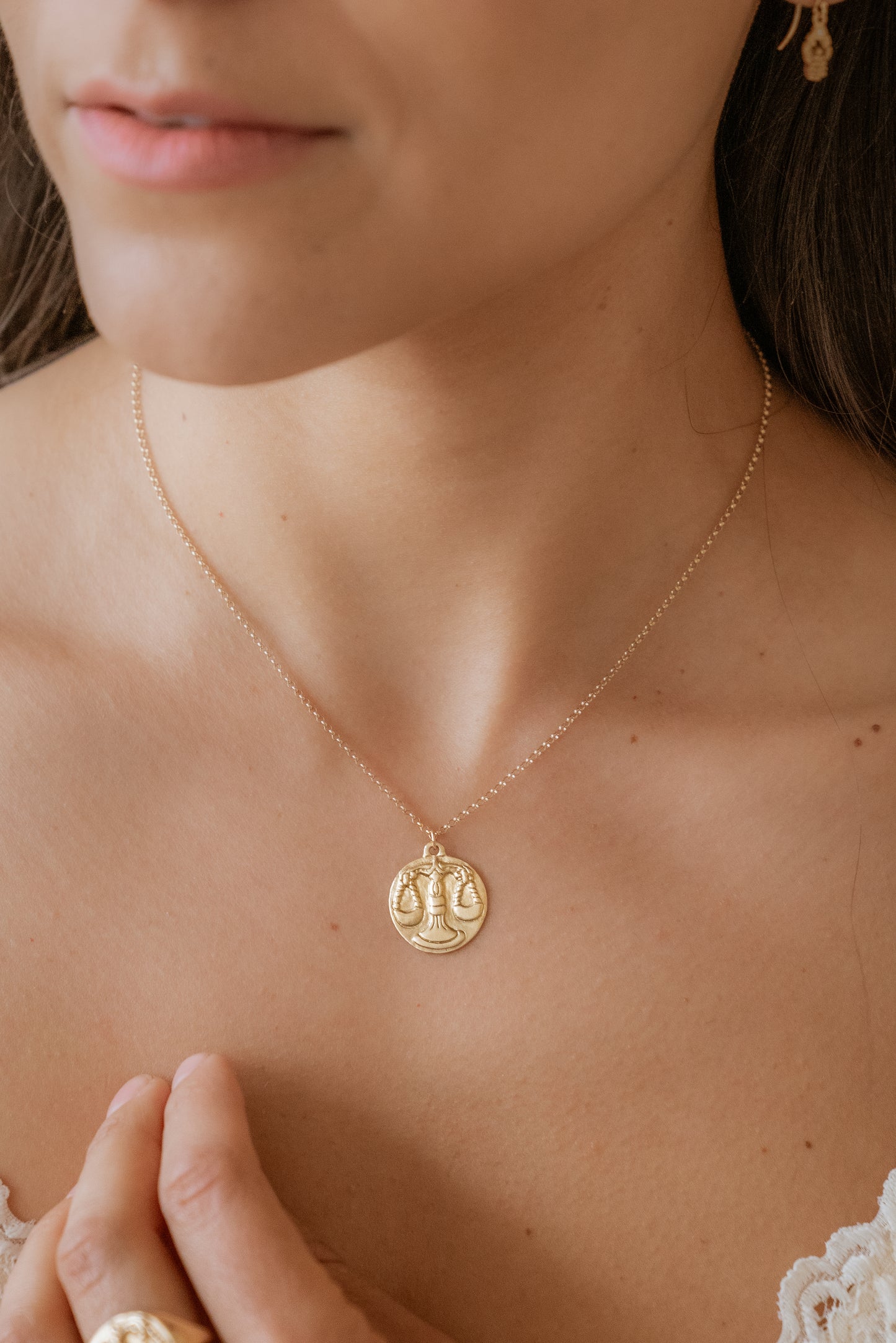 The seventh sign of the Zodiac, air sign Libra is an egalitarian peacemaker in search of harmony. Hand-carved scales of justice grace this pendant, creating a necklace that captures the power of the celestial sky.