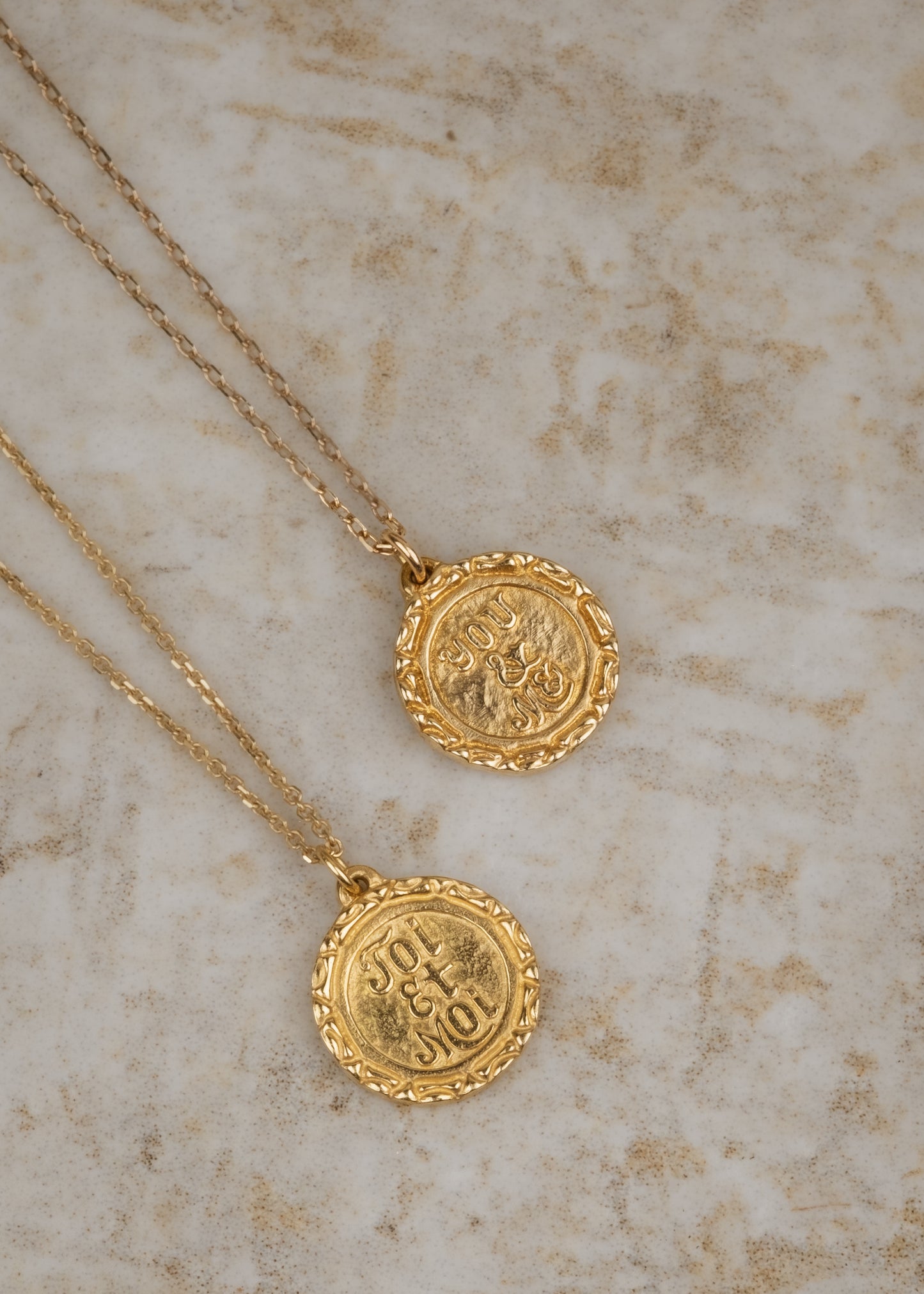 Inspired by “toi et moi” engagement rings from centuries past, the Toi et Moi necklace is a gold pendant engraved by hand to read “Toi et Moi” on one side and “You and Me” on the other. Delicate carving on the edges showcases the beauty of the gold—a piece that’s romantic, sweet, and a promise of things to come.