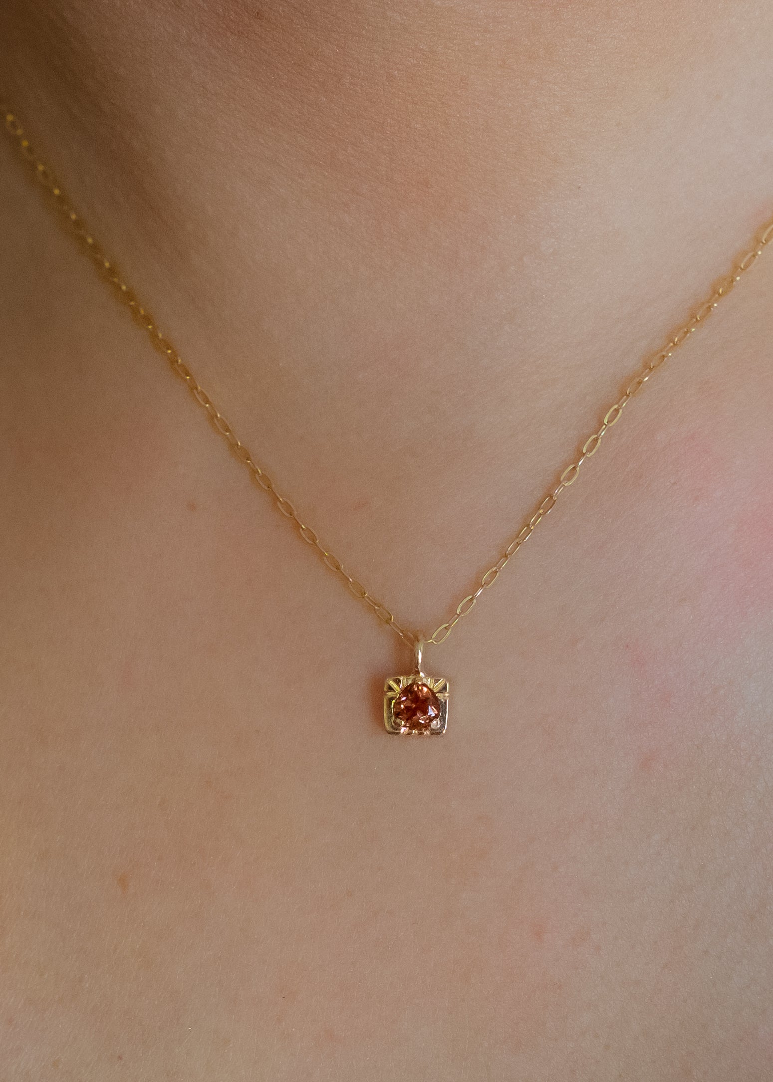 The fire of inspiration ignites with a single spark. Named after the Greek goddess of the hearth, the Vesta necklace features an engraved box-shaped gold charm with a tourmaline stone that glimmers like sacred embers–a piece that glows with promise and warmth.