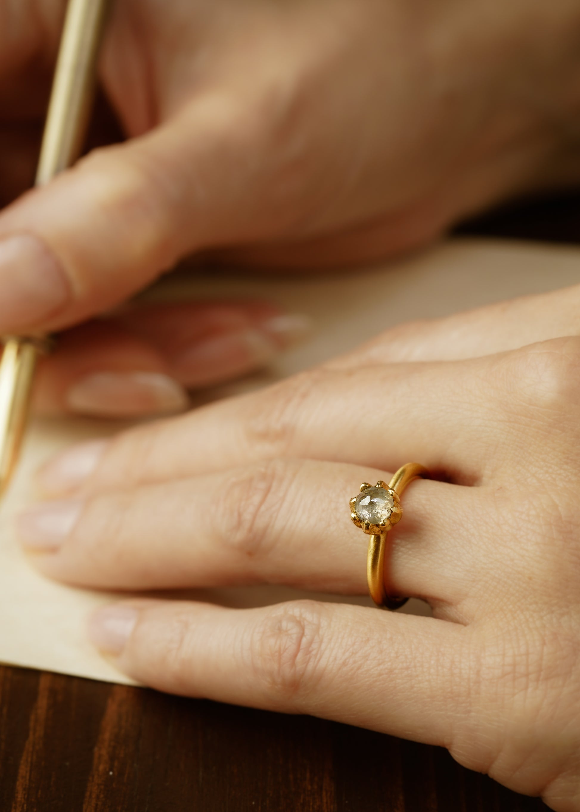 In simplicity, majesty is revealed. Inspired by the stark and graphic botanical photographs of Karl Blossfeldt, the Fleur ring creates a striking silhouette on the finger, its clean gold band showcasing a regal and romantic rose cut diamond.