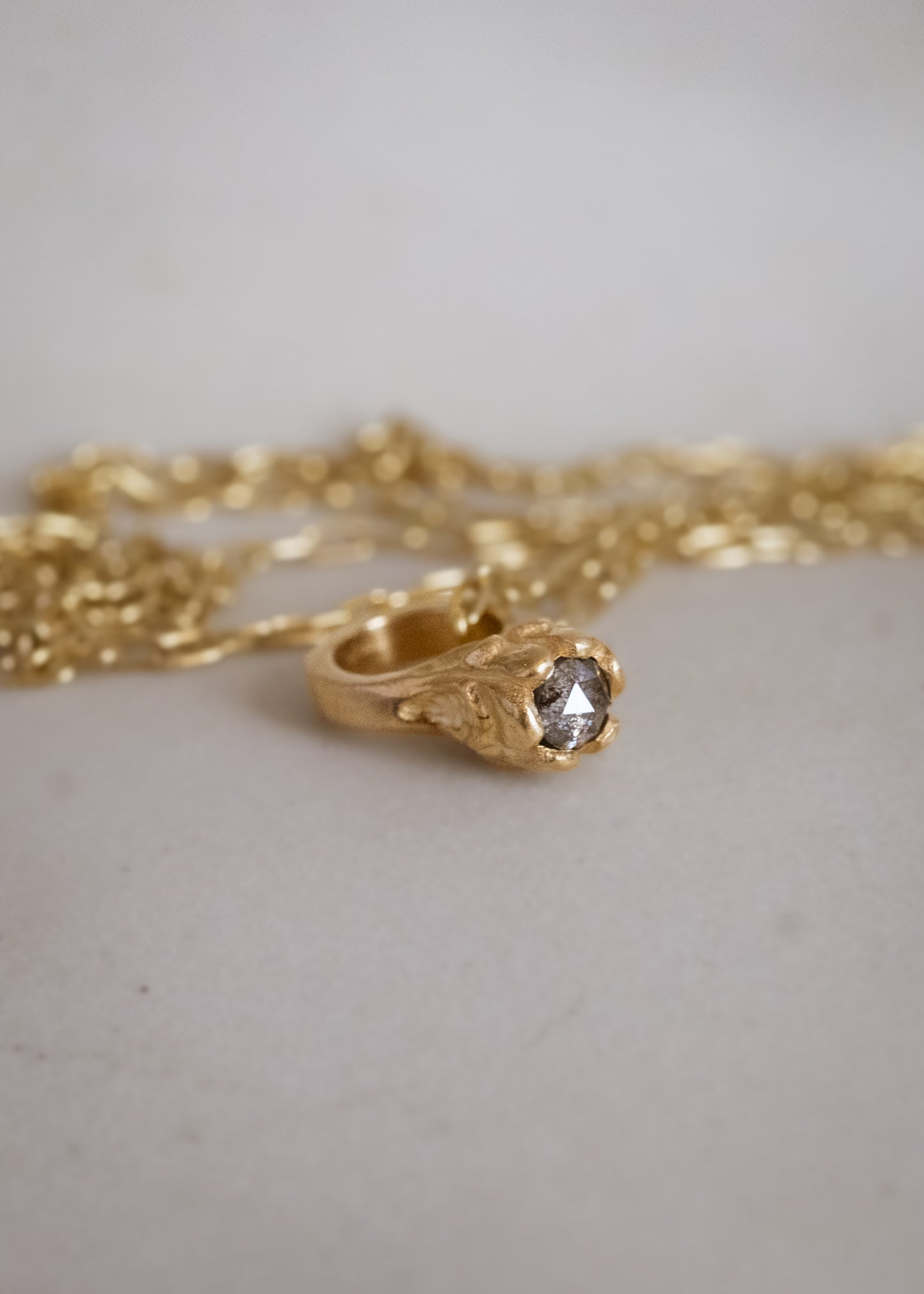 Inspired by a set of rings purchased for a childhood crush, the Babbey necklace captures the magic of those innocent days, infused now with refined sophistication. Hand-crafted gold petals reveal a stunning diamond, creating a delicate ring-shaped pendant perfect for celebrating new motherhood, sisterhood, friendship—or the promise of love in bloom.