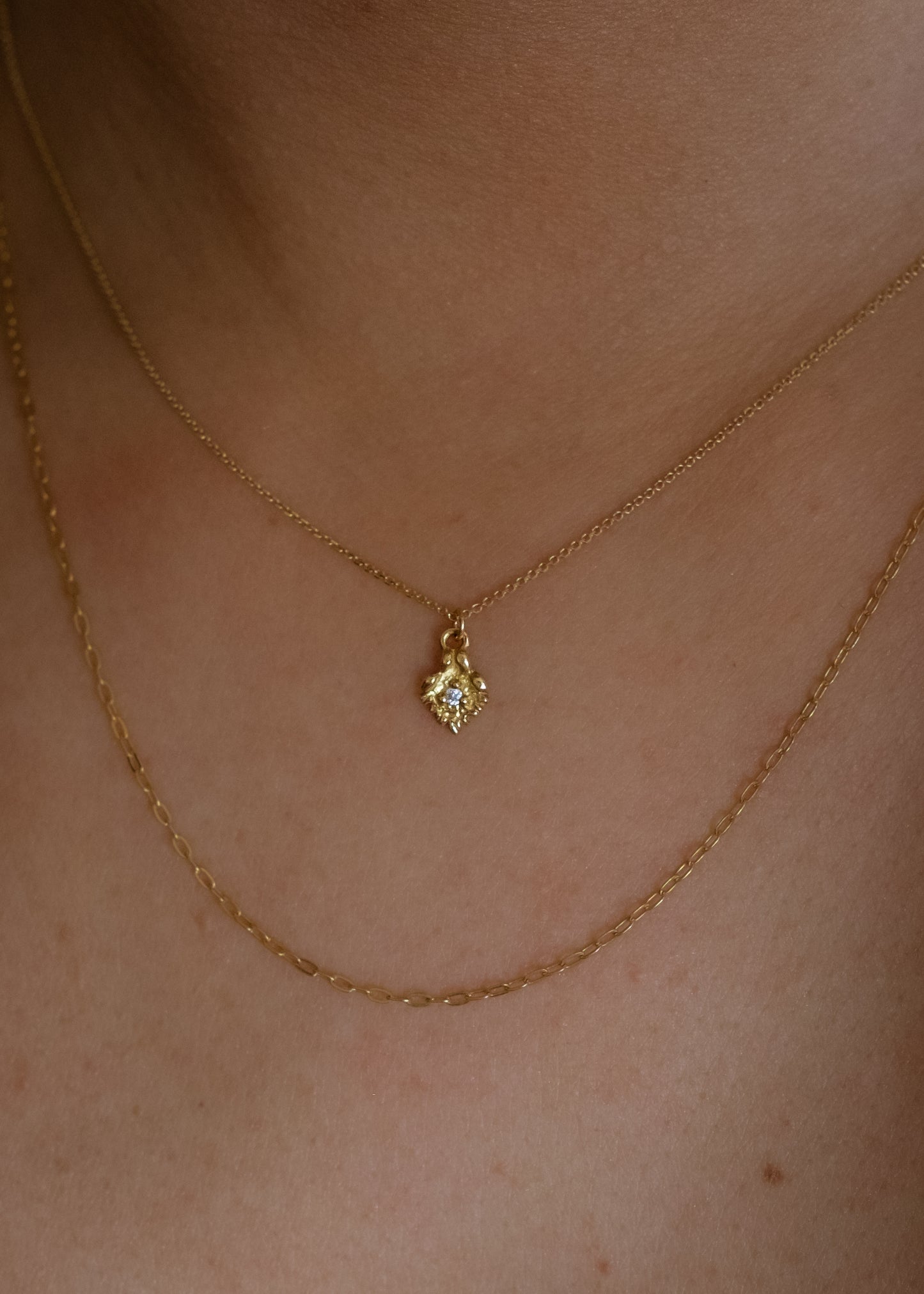 Like a small cabin nestled in the verdant mountainside of the Swiss Alps, the Chalet necklace invites a sense of wanderlust and adventure. Intricate textures give way to a single diamond that sparkles brilliantly against the gold that surrounds it—a snow-capped mountain top gleaming under the radiant warmth of the sun.