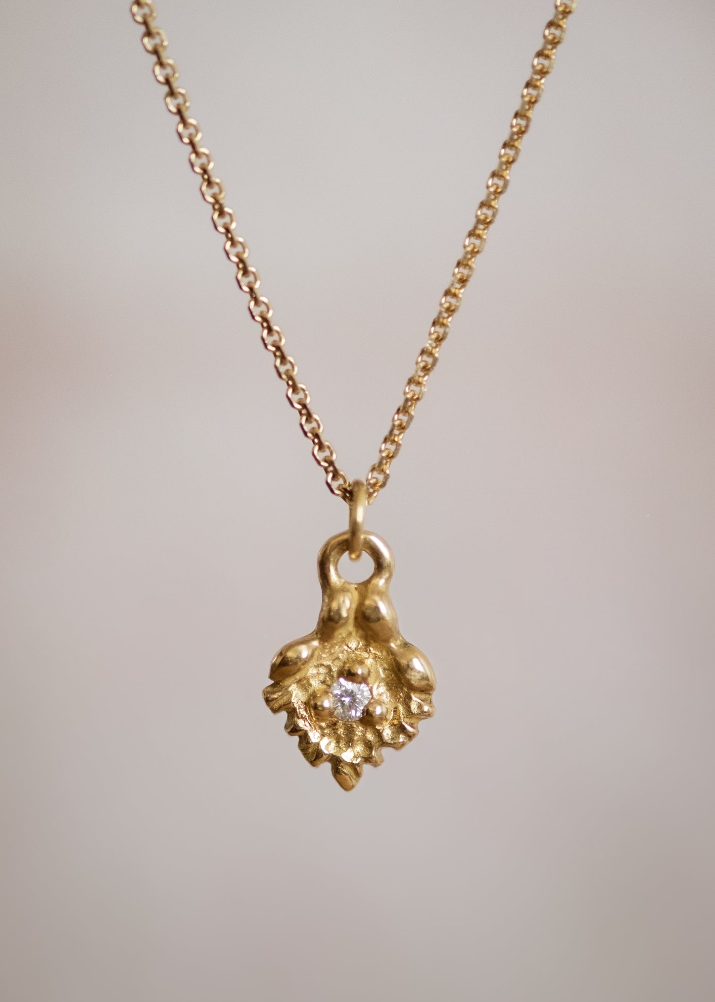 Like a small cabin nestled in the verdant mountainside of the Swiss Alps, the Chalet necklace invites a sense of wanderlust and adventure. Intricate textures give way to a single diamond that sparkles brilliantly against the gold that surrounds it—a snow-capped mountain top gleaming under the radiant warmth of the sun.