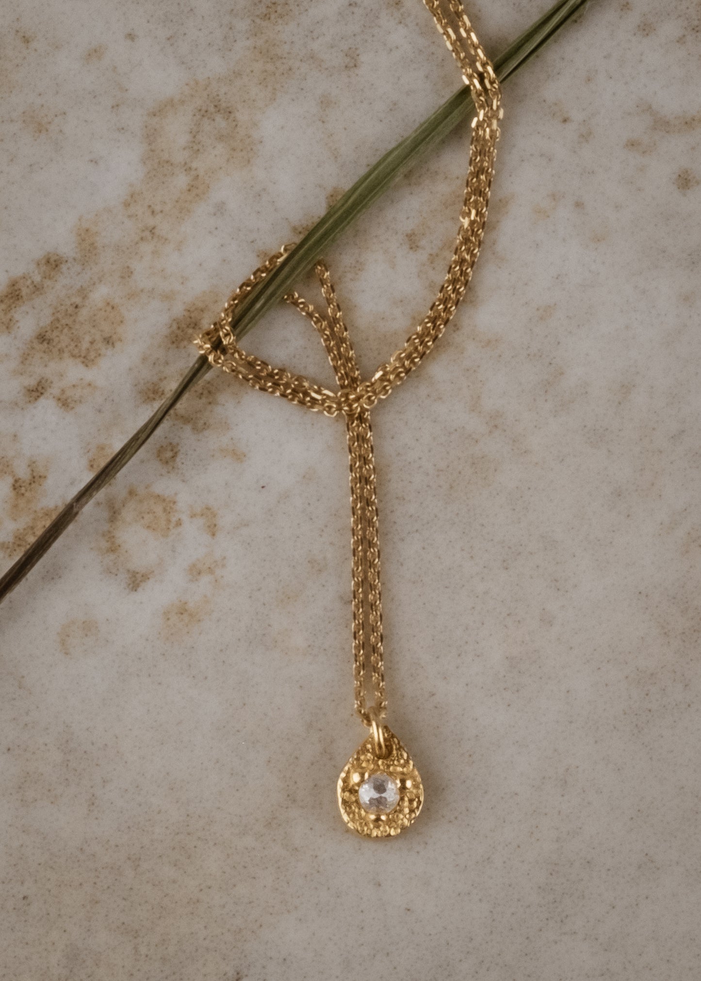 A romantic journey that transcends time. The Drop necklace merges a circle of understated hand-carved gold beads with ornate rose cut diamonds for a dangling romantic style that feels as at home today as it does in an antique jewelry box.