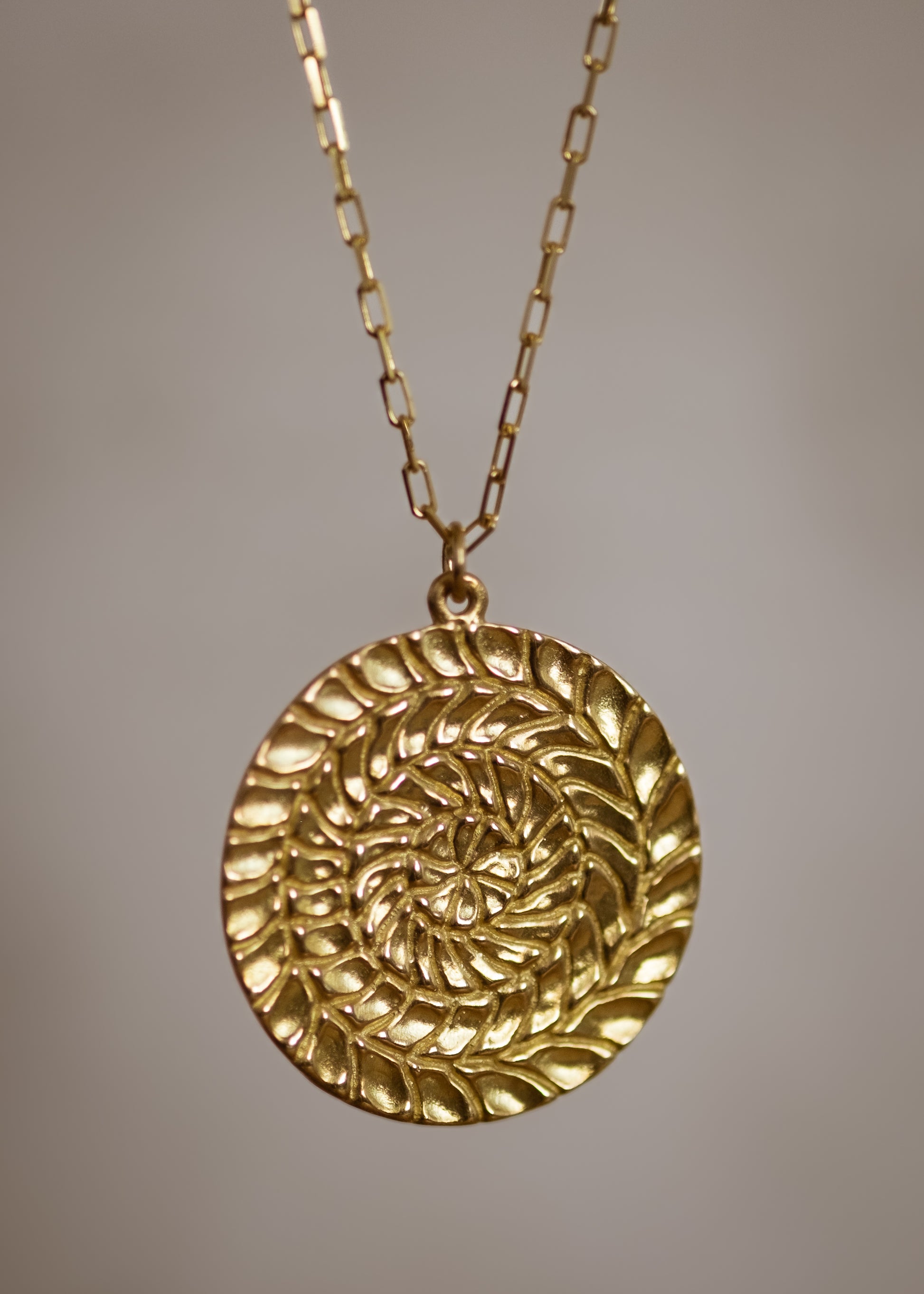 Named for Busby Berkely’s wife, the Etta necklace is a kaleidoscopic wonder that mirrors his elaborate geometric choreography. Four concentric circles, each detailed by hand, create a hypnotic and substantial pendant necklace as timeless as Berkeley’s black and white films.