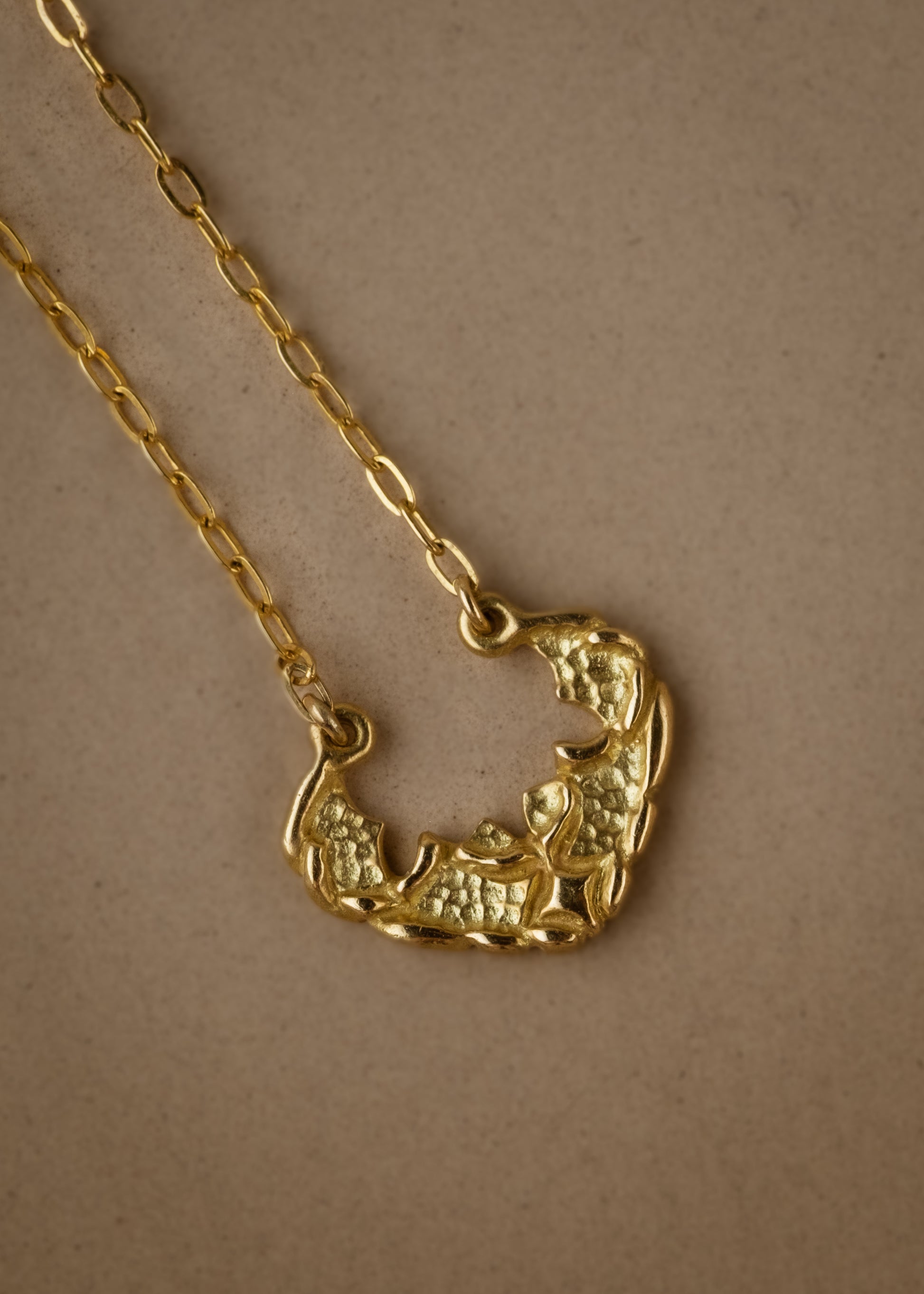 Named for the goddess of the sea, the Sedna necklace mirrors the undulating rhythm of the ocean. Gold waves expand and recede, revealing detailed texture that invites the eye to linger—a piece evocative of infinite strength and power.