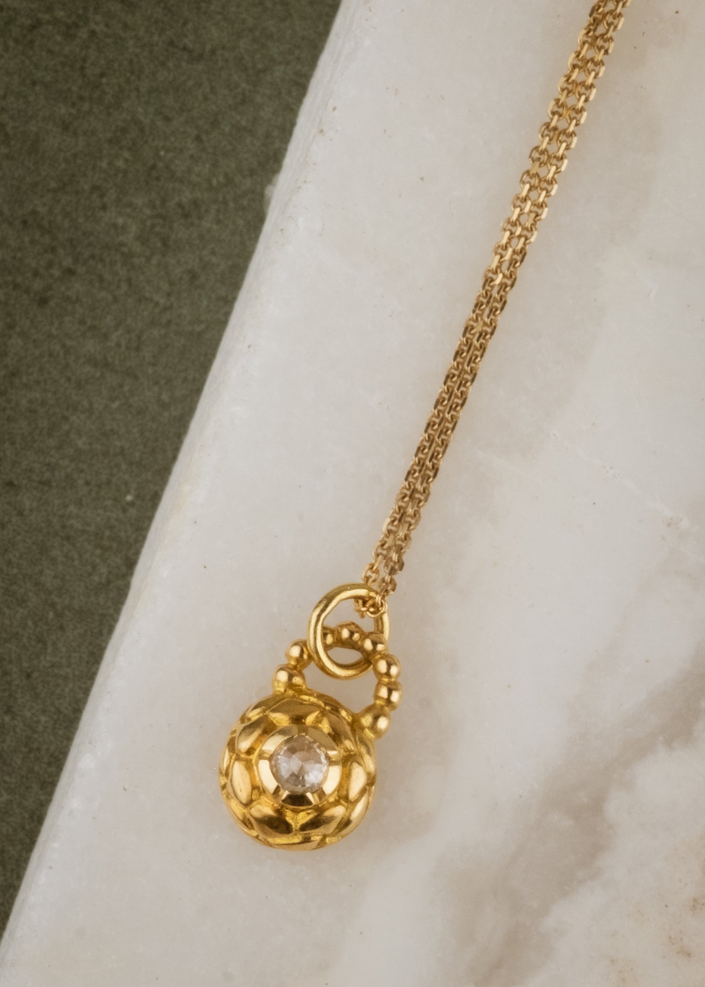 Featuring intricate hand-carved beads that center around a brilliant rose cut diamond, the Marquis necklace is fit for royalty and reimagined for everyday wear.