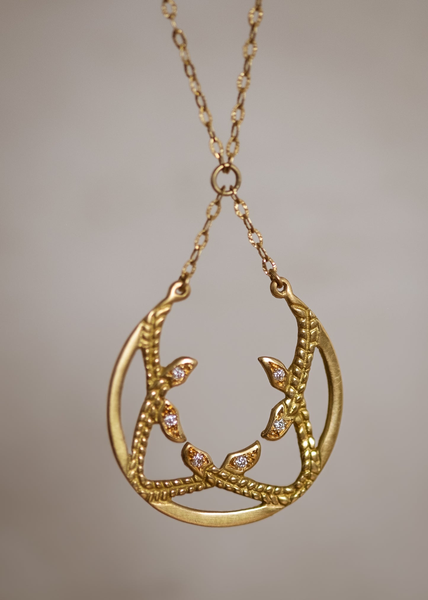Inspired by the female prophets who share its name, the Sibyl necklace whispers the mysteries of the future while echoing stories of days past. Smooth open-work crescents give way to intertwining textured elements, hand-carved to draw the eye in and reveal brilliant diamond accents—a substantial and haunting design that’s decidedly feminine.