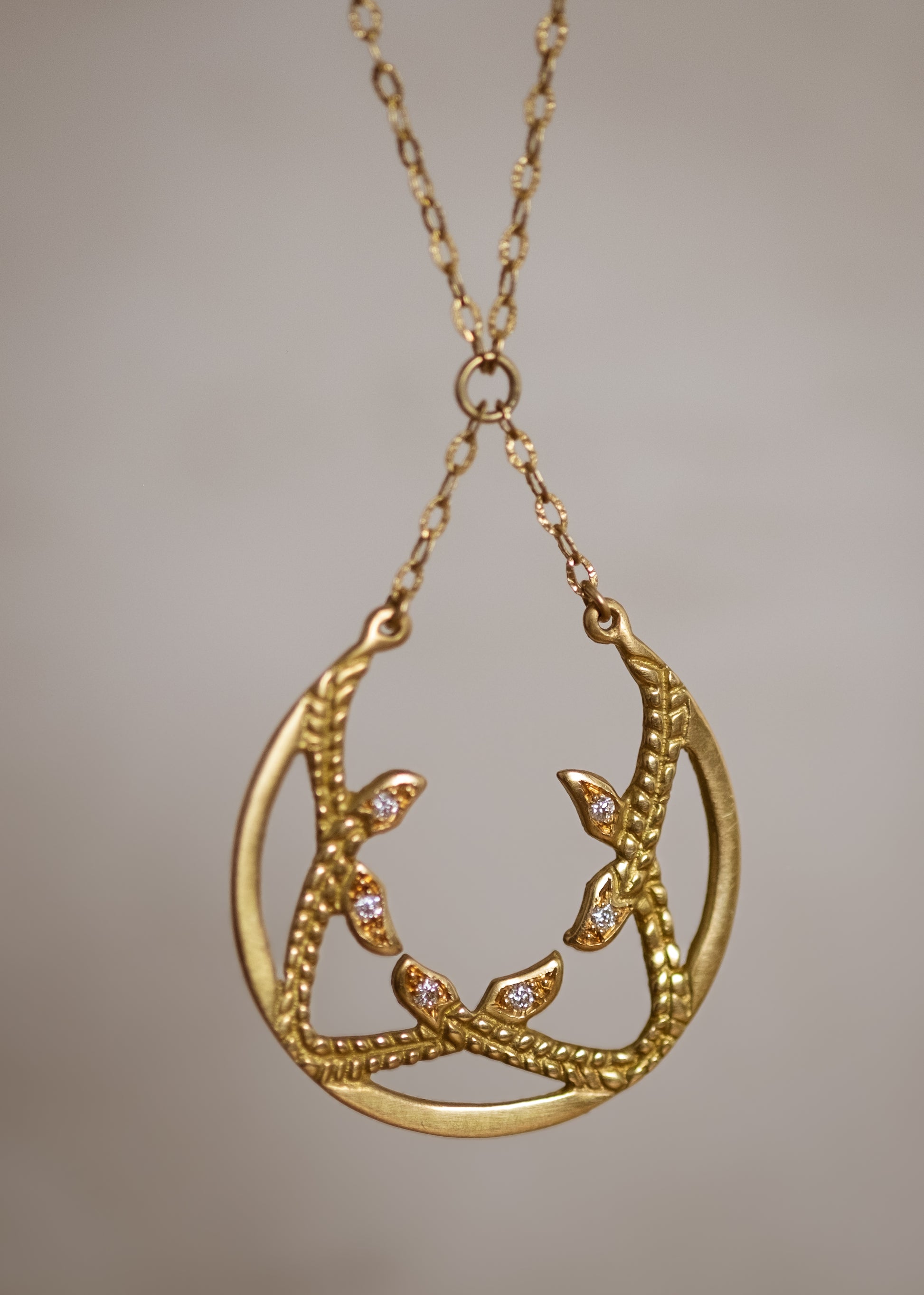 Inspired by the female prophets who share its name, the Sibyl necklace whispers the mysteries of the future while echoing stories of days past. Smooth open-work crescents give way to intertwining textured elements, hand-carved to draw the eye in and reveal brilliant diamond accents—a substantial and haunting design that’s decidedly feminine.