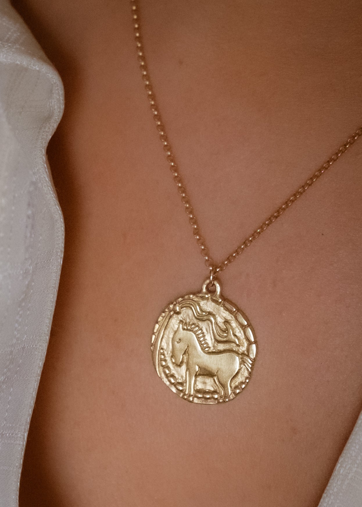 With its hand-carved horse—an embodiment of beauty and strength— and intricate detail, the Coronation necklace marries the artistry of metalwork with a spirit of whimsy and independence. A powerful totem of personal sovereignty.