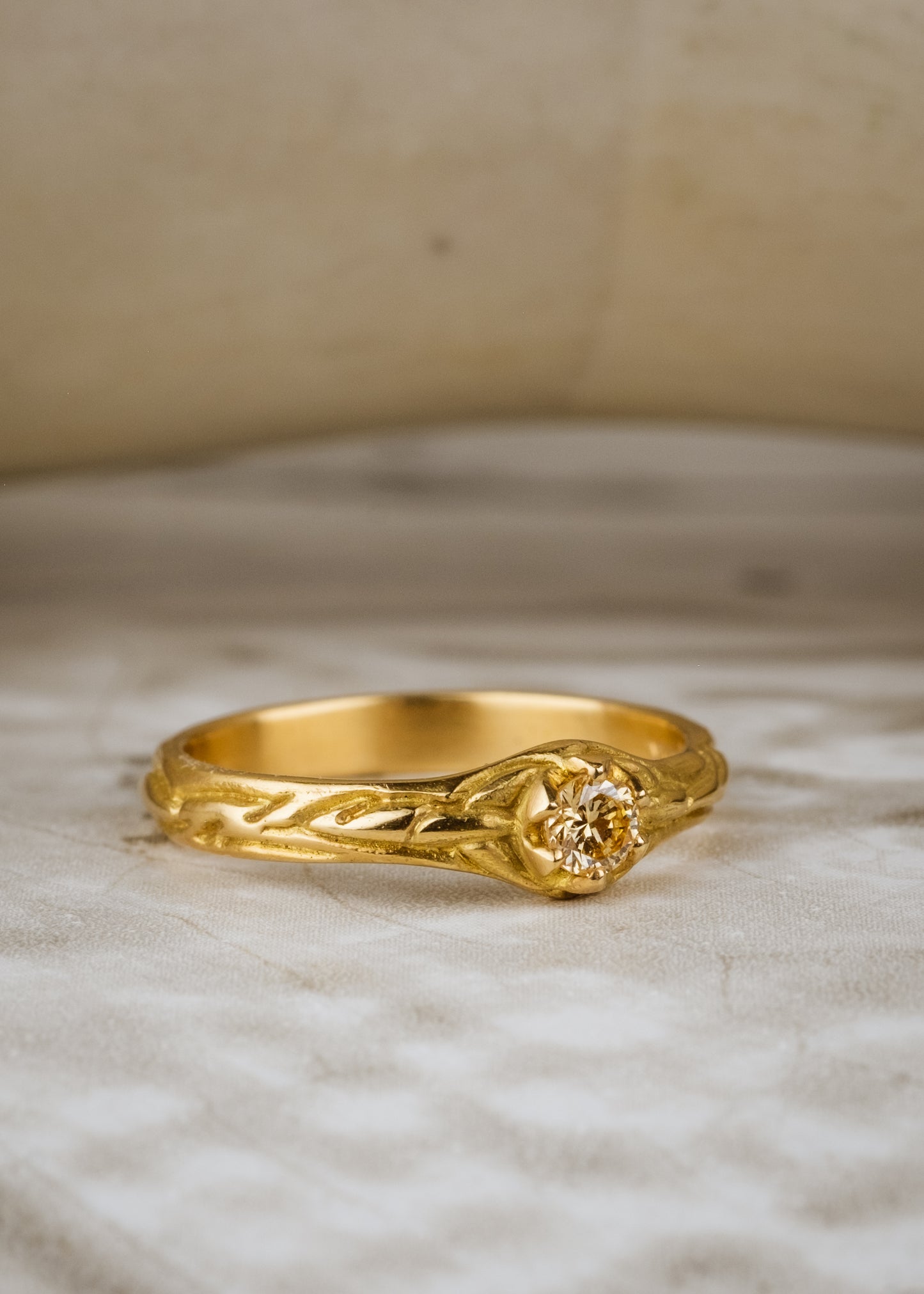 Inspired by the southern constellation, the Ara ring reflects the brilliance of the night sky with a champagne diamond that sits flush against a hand-carved gold band—a piece as timeless as the stars themselves.