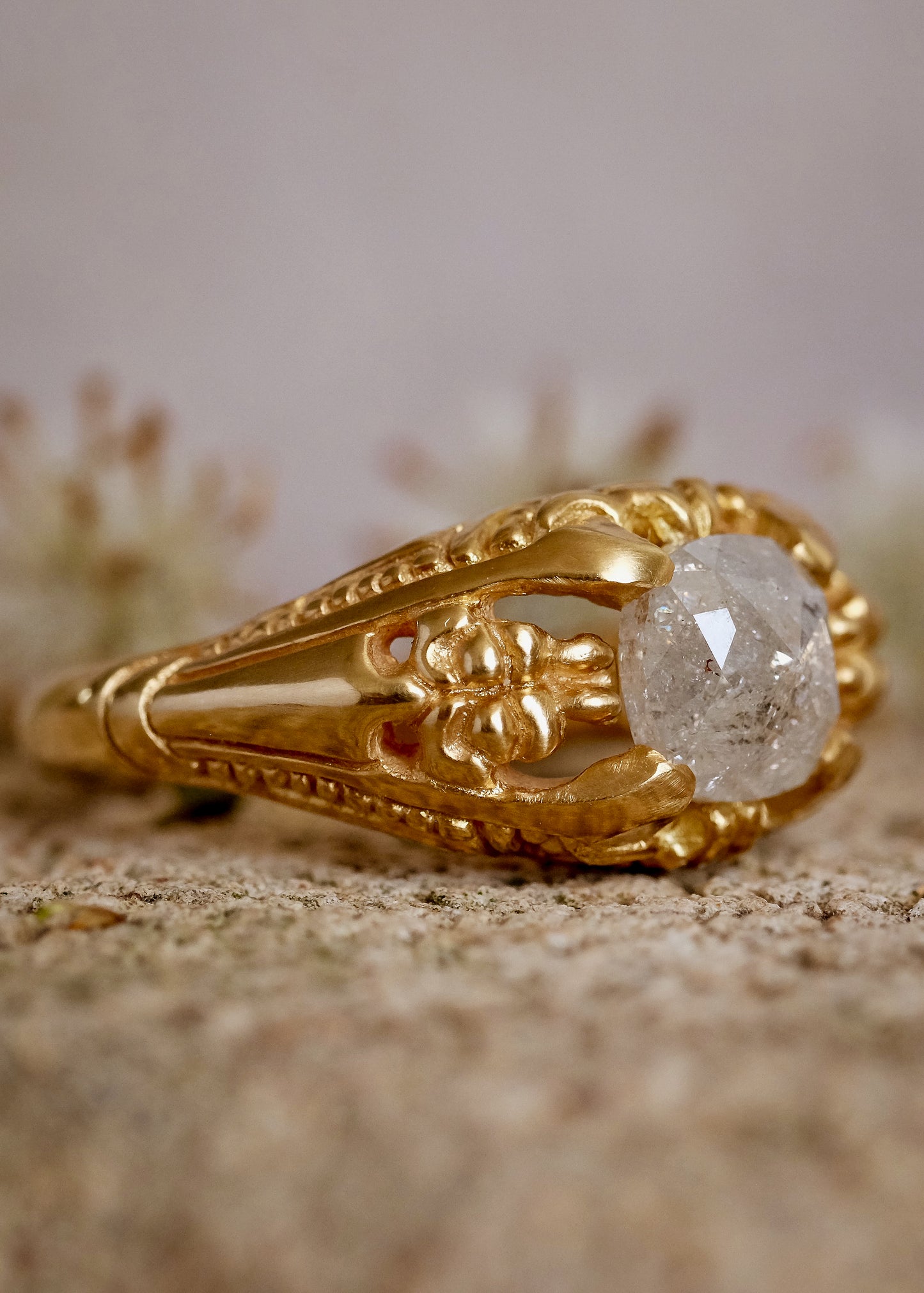 Capturing the ornate details of the Victorian era, the Violette ring was inspired by the love between Prince Albert and Queen Victoria. A substantial gold band is rich in intricate detail, showcasing craftsmanship with each bead, curve and open space. A stunning rose cut diamond sits flush among the prongs, creating a romantic ring to cherish for the ages.