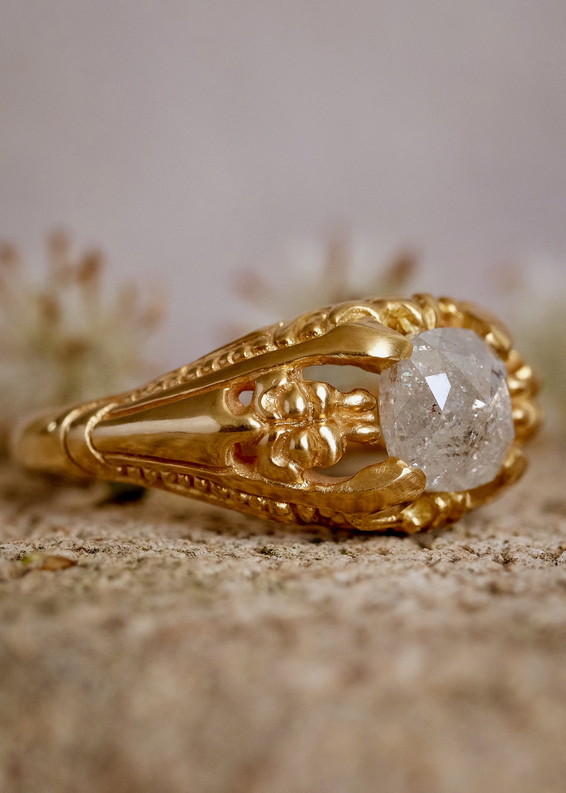 Capturing the ornate details of the Victorian era, the Violette ring was inspired by the love between Prince Albert and Queen Victoria. A substantial gold band is rich in intricate detail, showcasing craftsmanship with each bead, curve and open space. A stunning rose cut diamond sits flush among the prongs, creating a romantic ring to cherish for the ages.