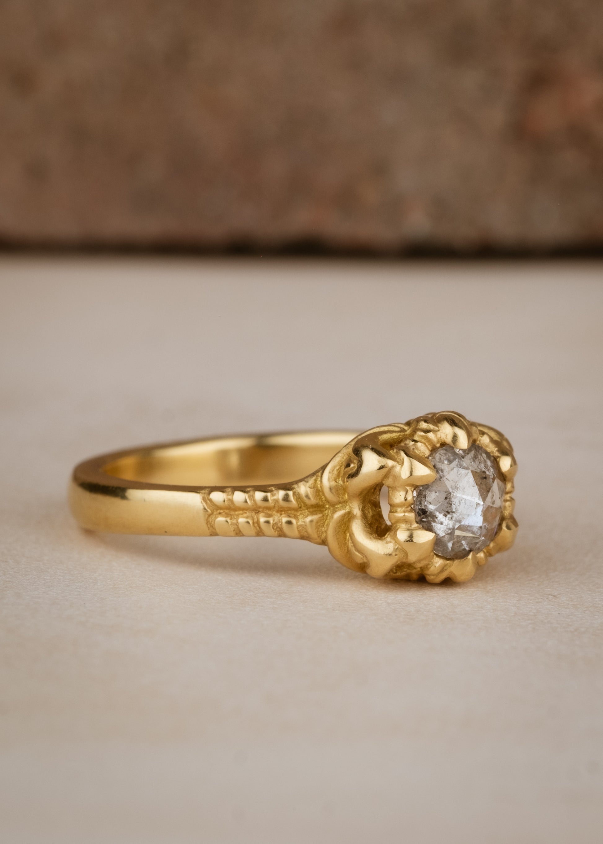 A mythical creature who continues to captivate the imagination, Lilith’s hair was referred to by the poet Rosetti as “the first gold.” A gleaming rose cut diamond is set among an intricately detailed gold band—an homage to Lilith’s ability to cast her spell wherever she goes.