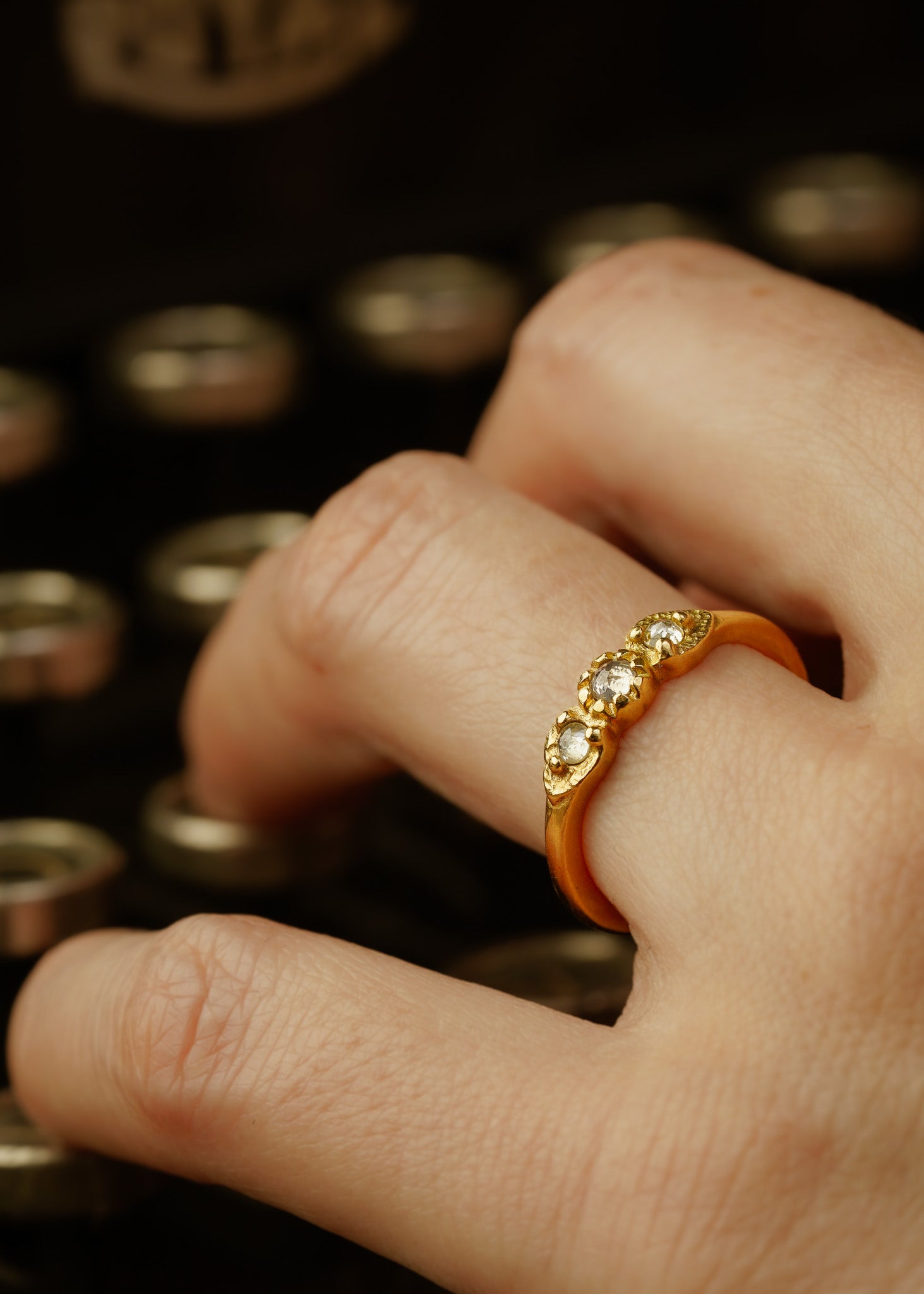 With a timeless and romantic aesthetic, the Trio ring showcases a gold band that has been hand-designed to create delicate beading and texture, encasing three luminous rose cut diamonds—an old world style reimagined for our modern moment.