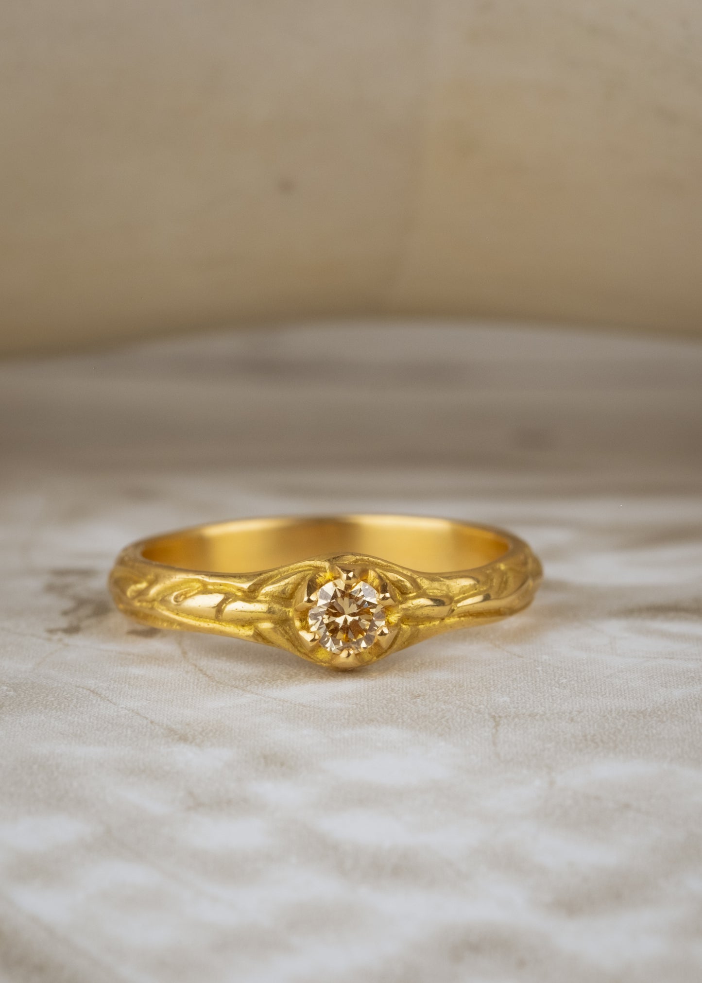 Inspired by the southern constellation, the Ara ring reflects the brilliance of the night sky with a champagne diamond that sits flush against a hand-carved gold band—a piece as timeless as the stars themselves.